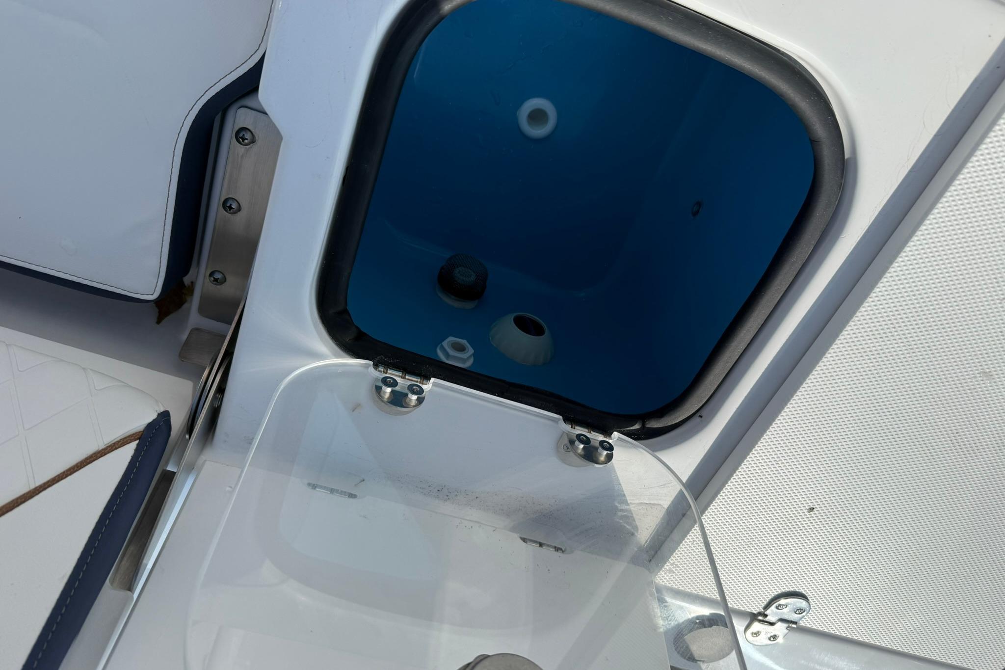 Open hatch on 2026 Stingray 173 CC boat, showing interior compartment.