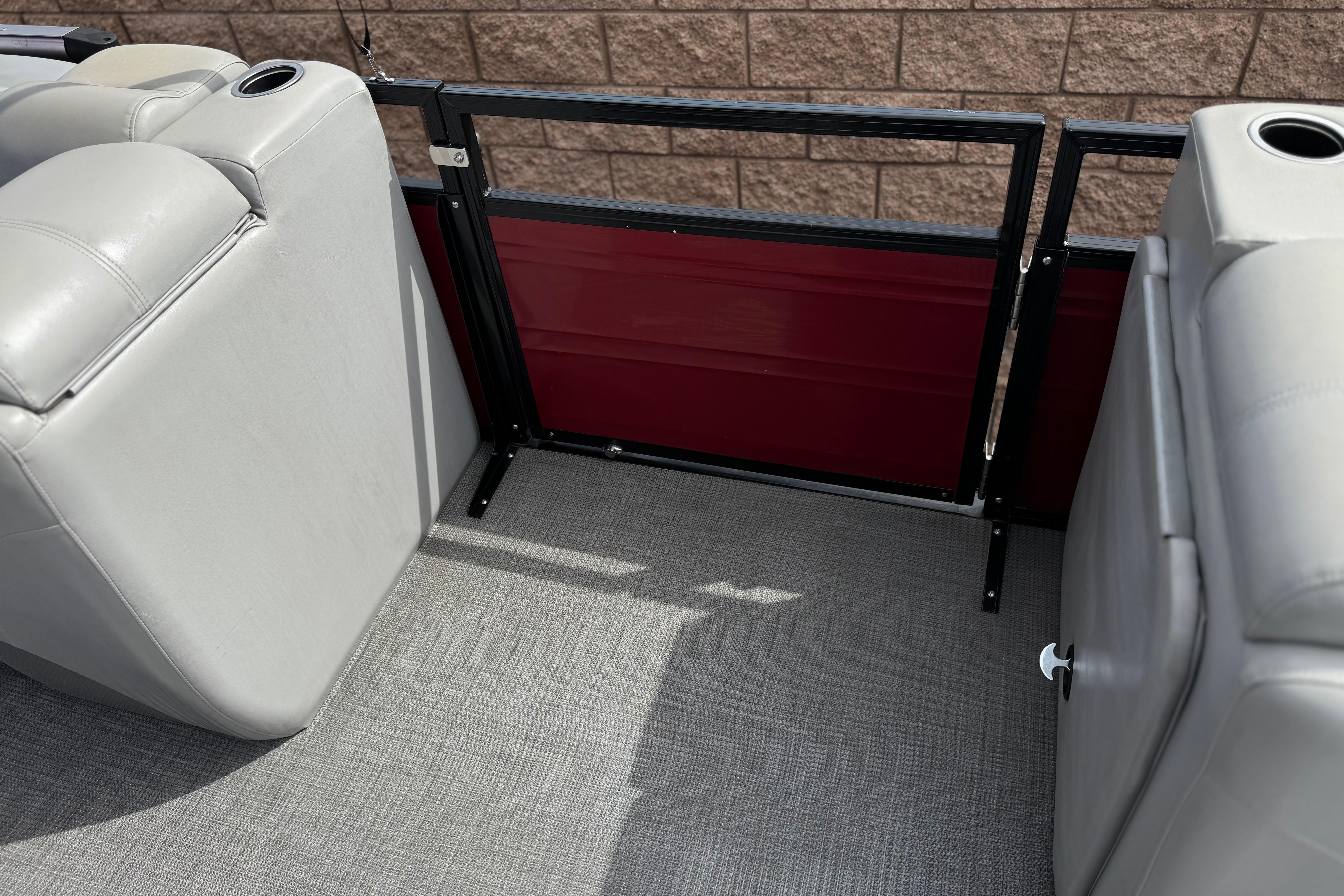 2022 Regency 250 DL3 boat interior with gray seating and red paneling.