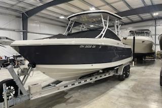 2022 Robalo R247 Dual Console boat on trailer in indoor storage facility.