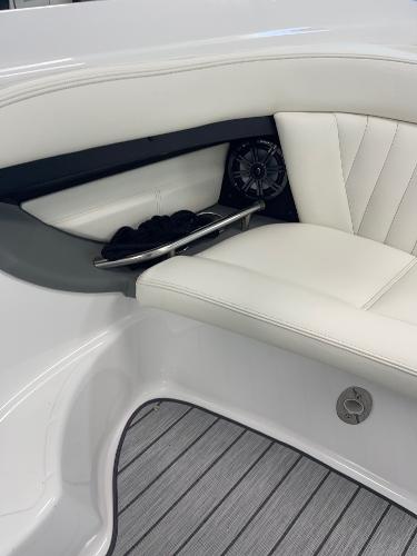 Luxury seating in a 2005 Cobalt 343 boat with white upholstery and speaker.