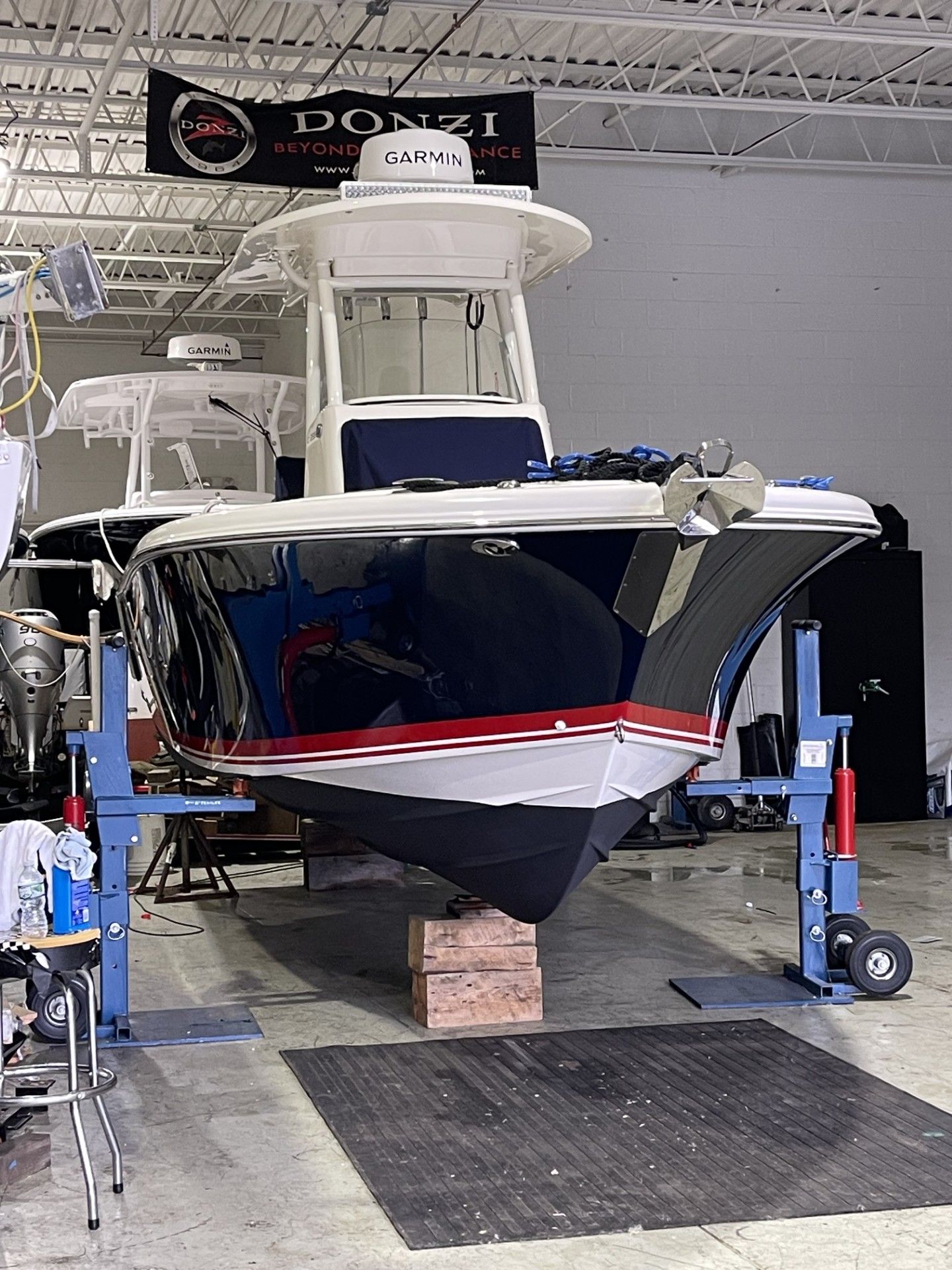 2022 Pursuit C 238 Center Console boat in workshop.