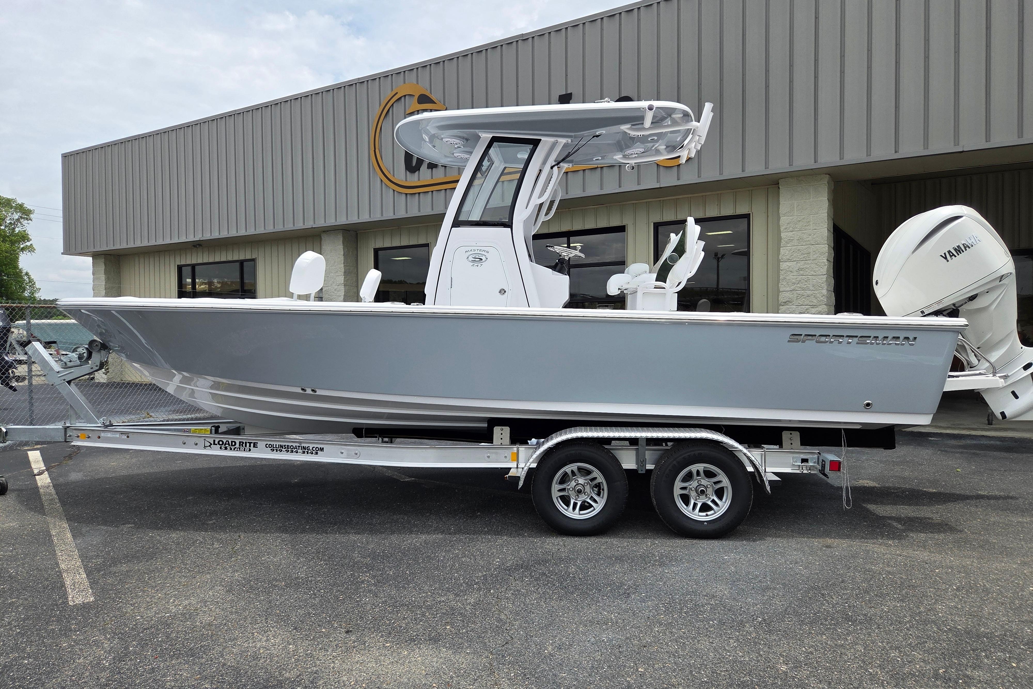 2026 Sportsman Masters 247 Bay Boat on trailer outside dealership.