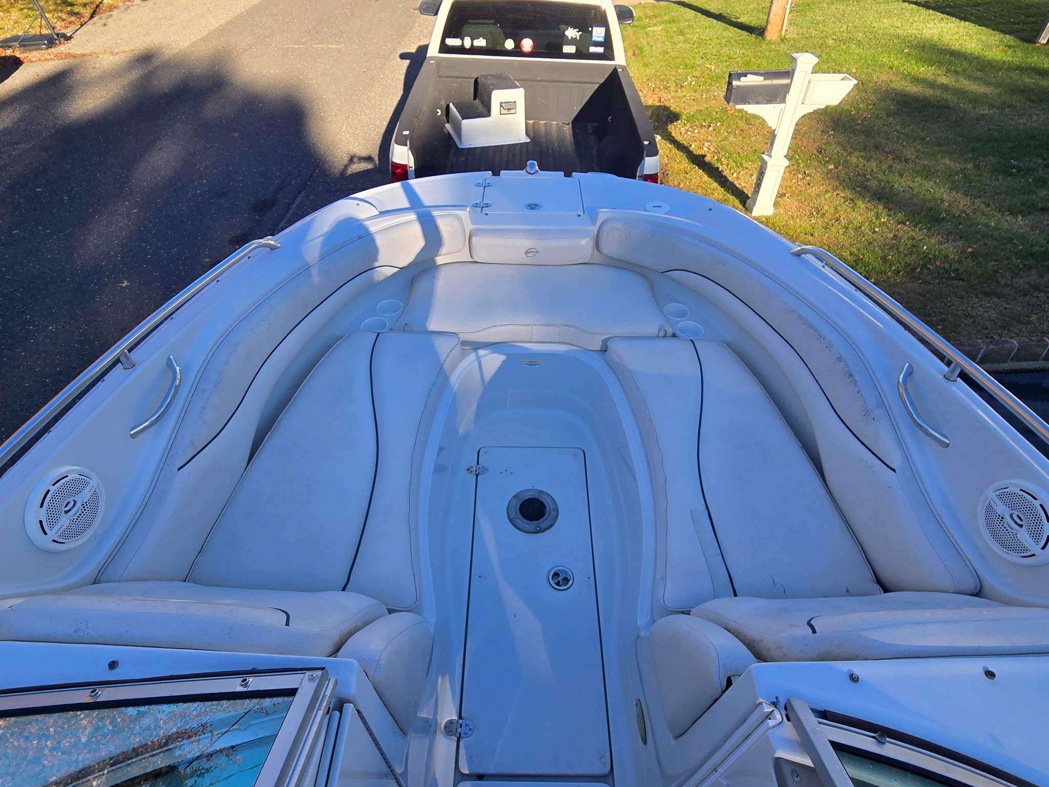 The image shows the bow area of a 2005 Crownline 240 EX boat with white upholstery.