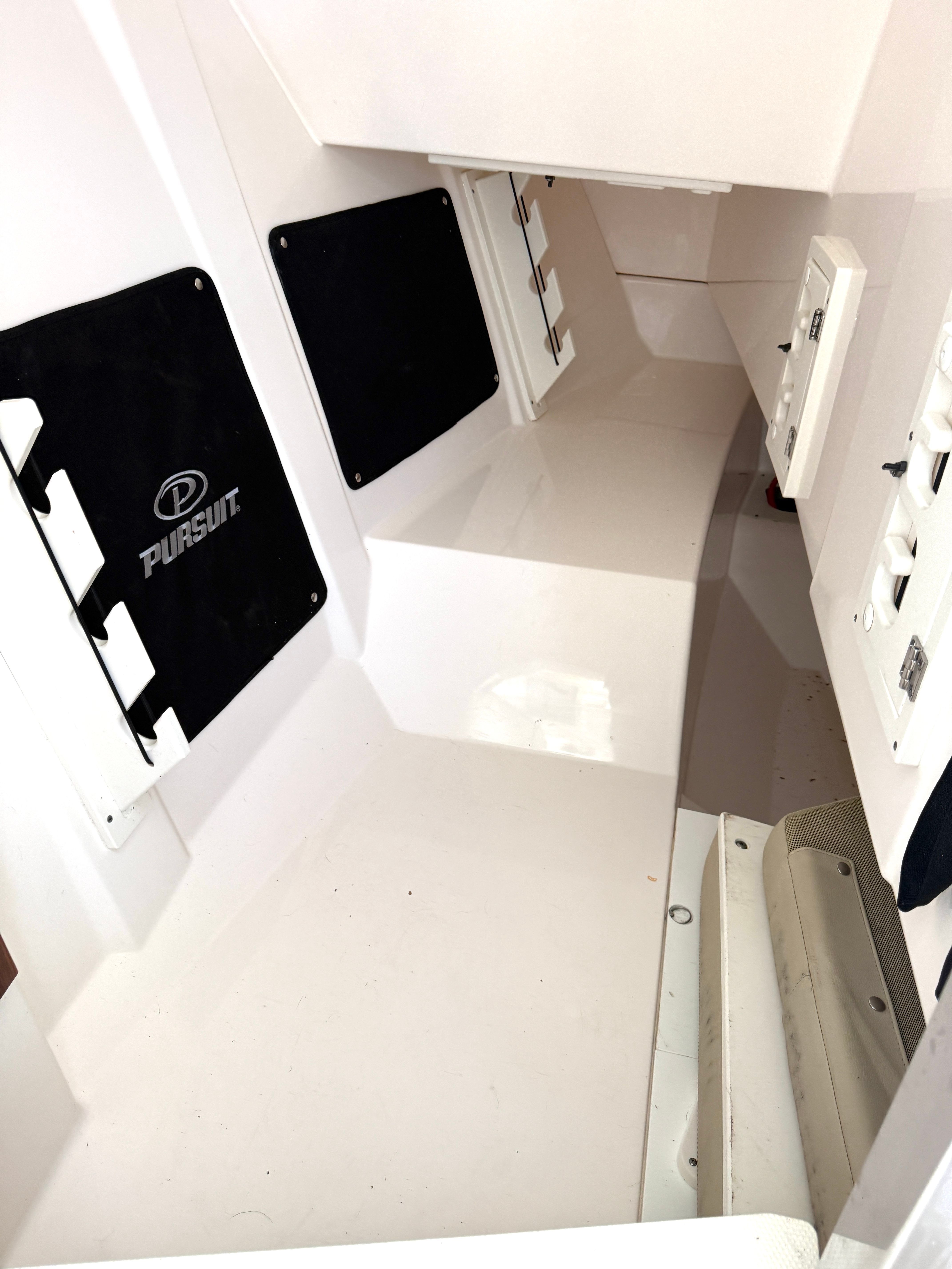 Interior of a 2017 Pursuit DC 295 Dual Console boat with white surfaces.