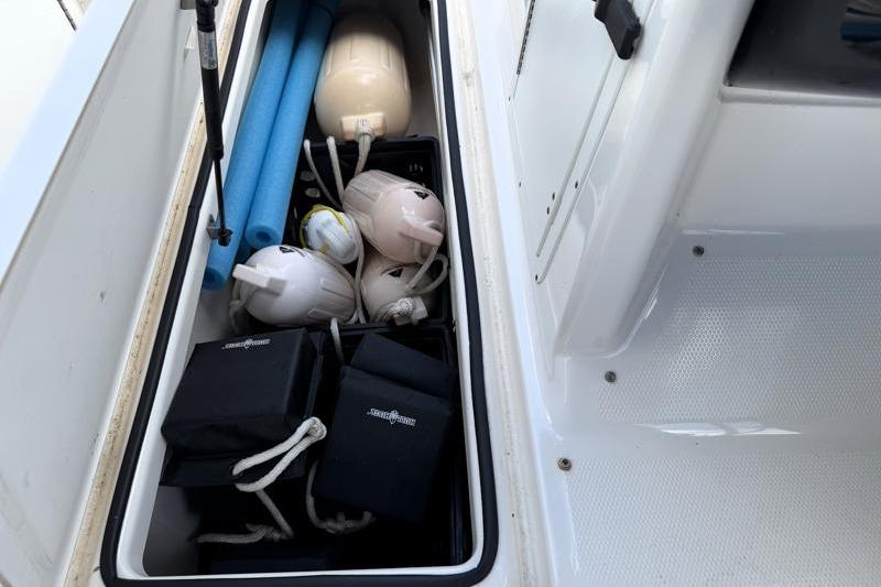 Storage compartment of 2017 Yamaha SX210 boat with fenders and accessories.