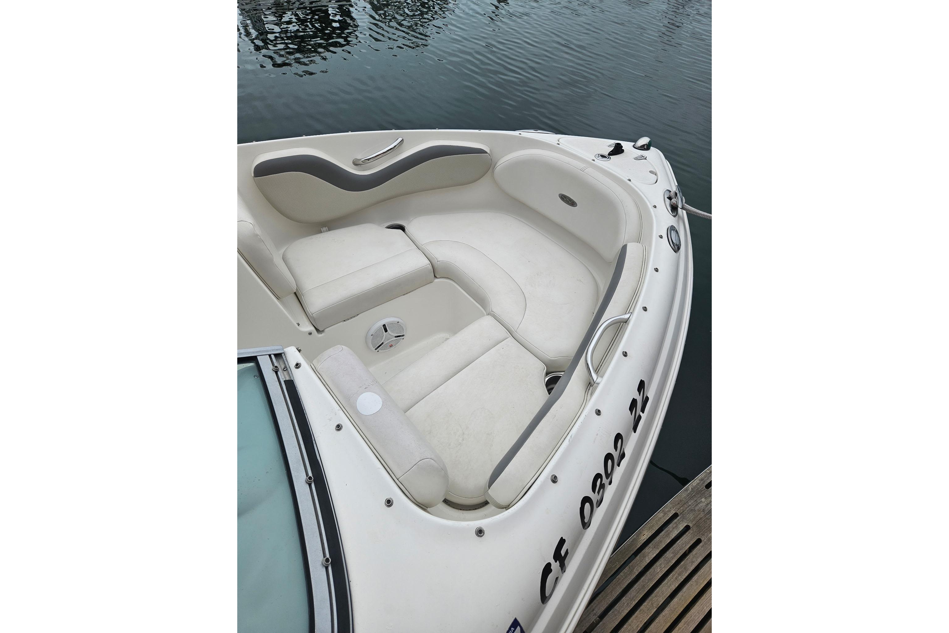 2006 Chaparral 190 SSi boat interior with white seating, docked by water.