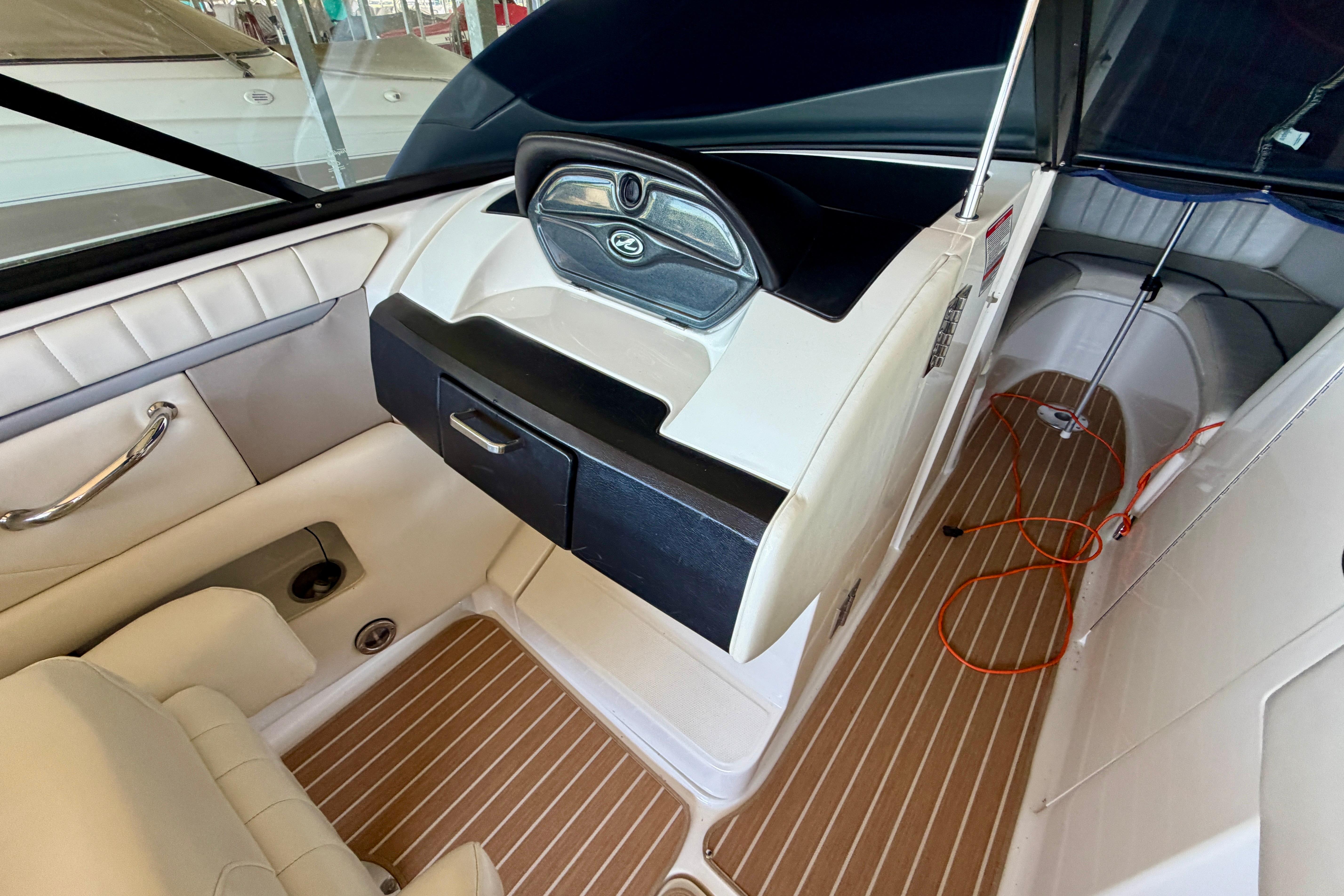 Interior of a 2007 Sea Ray 270 SLX boat, featuring sleek design and wood-patterned flooring.