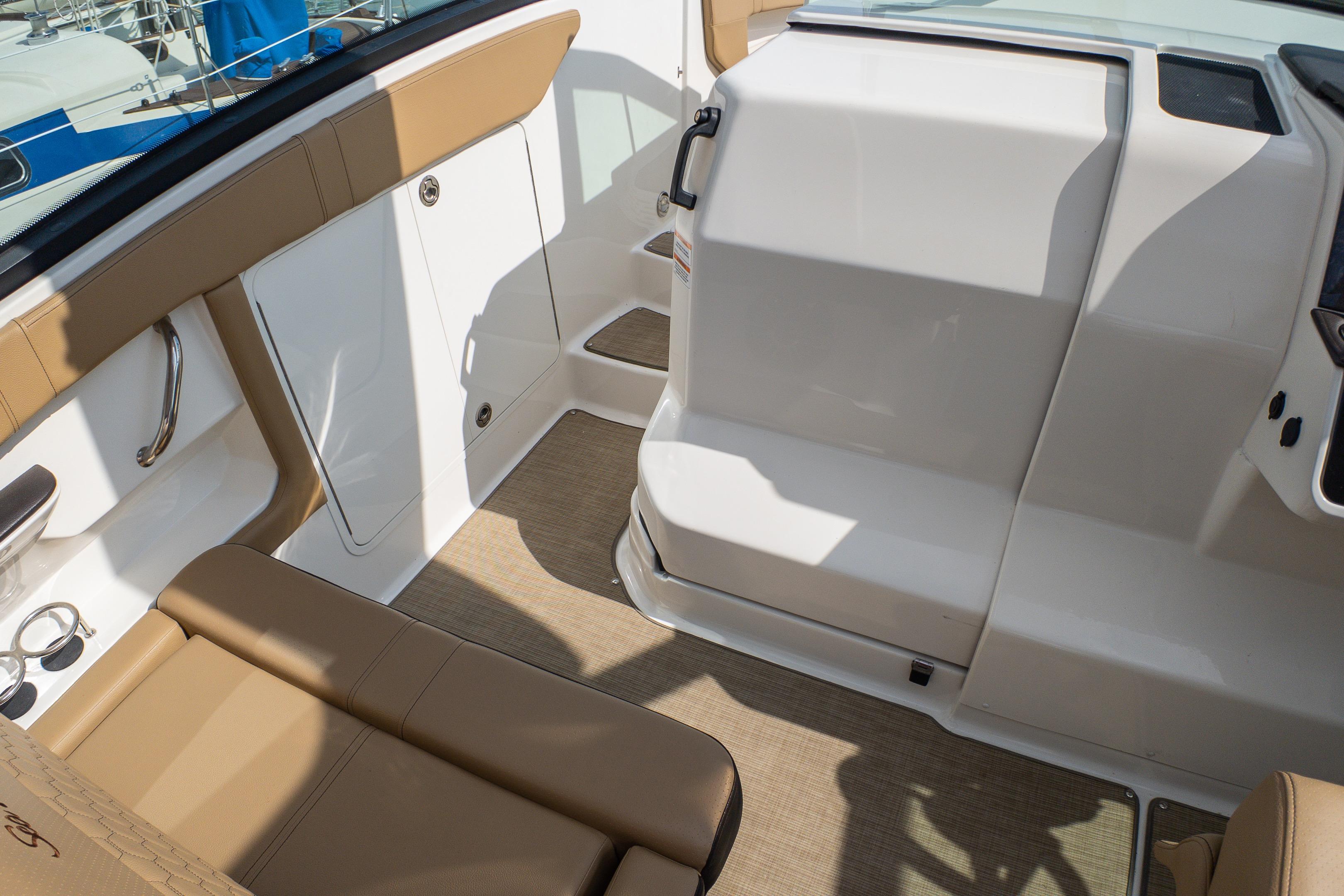 Interior view of 2019 Sea Ray Sundancer 320 boat with tan seating and white surfaces.