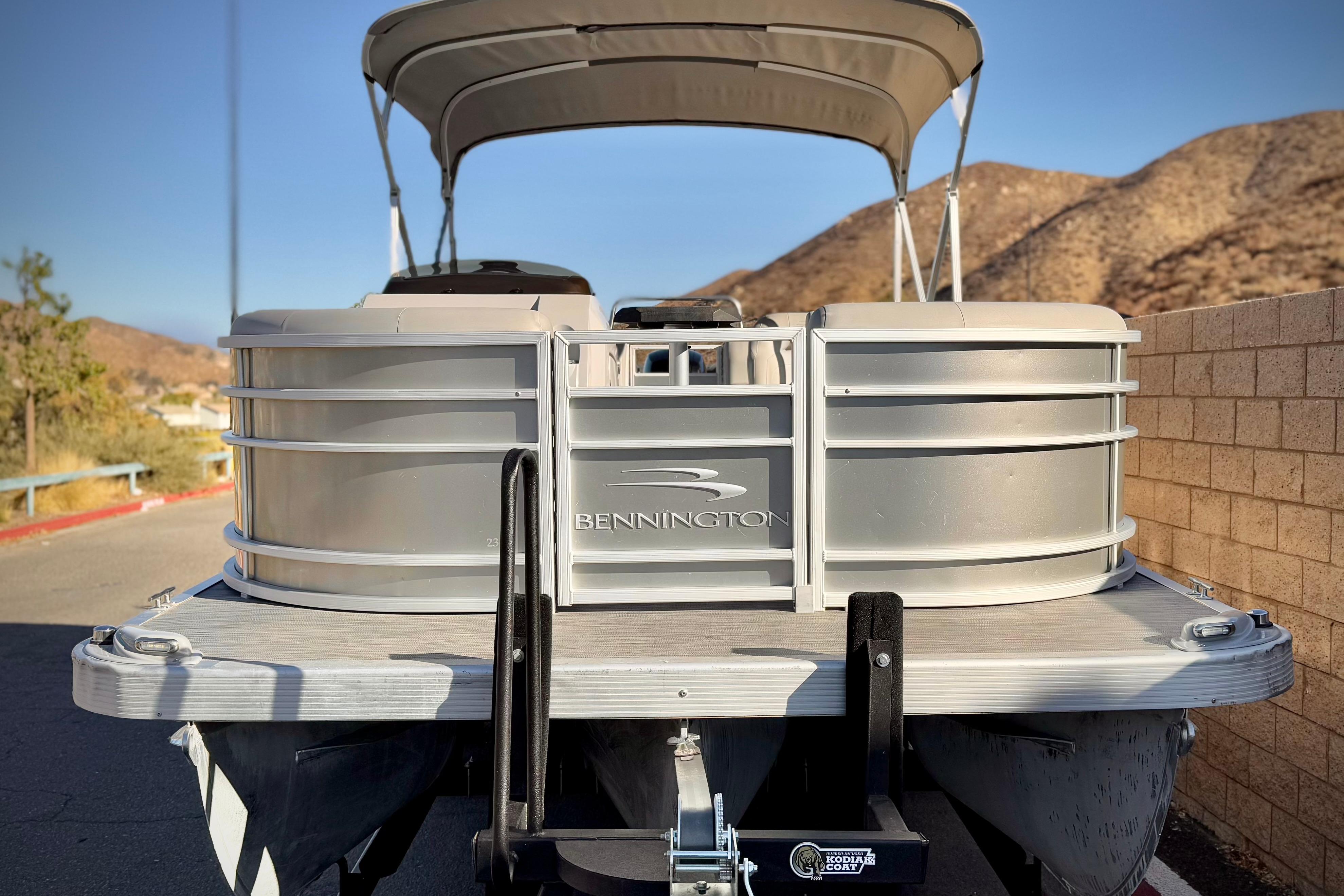 2021 Bennington 23LSR pontoon boat parked with scenic mountain backdrop.