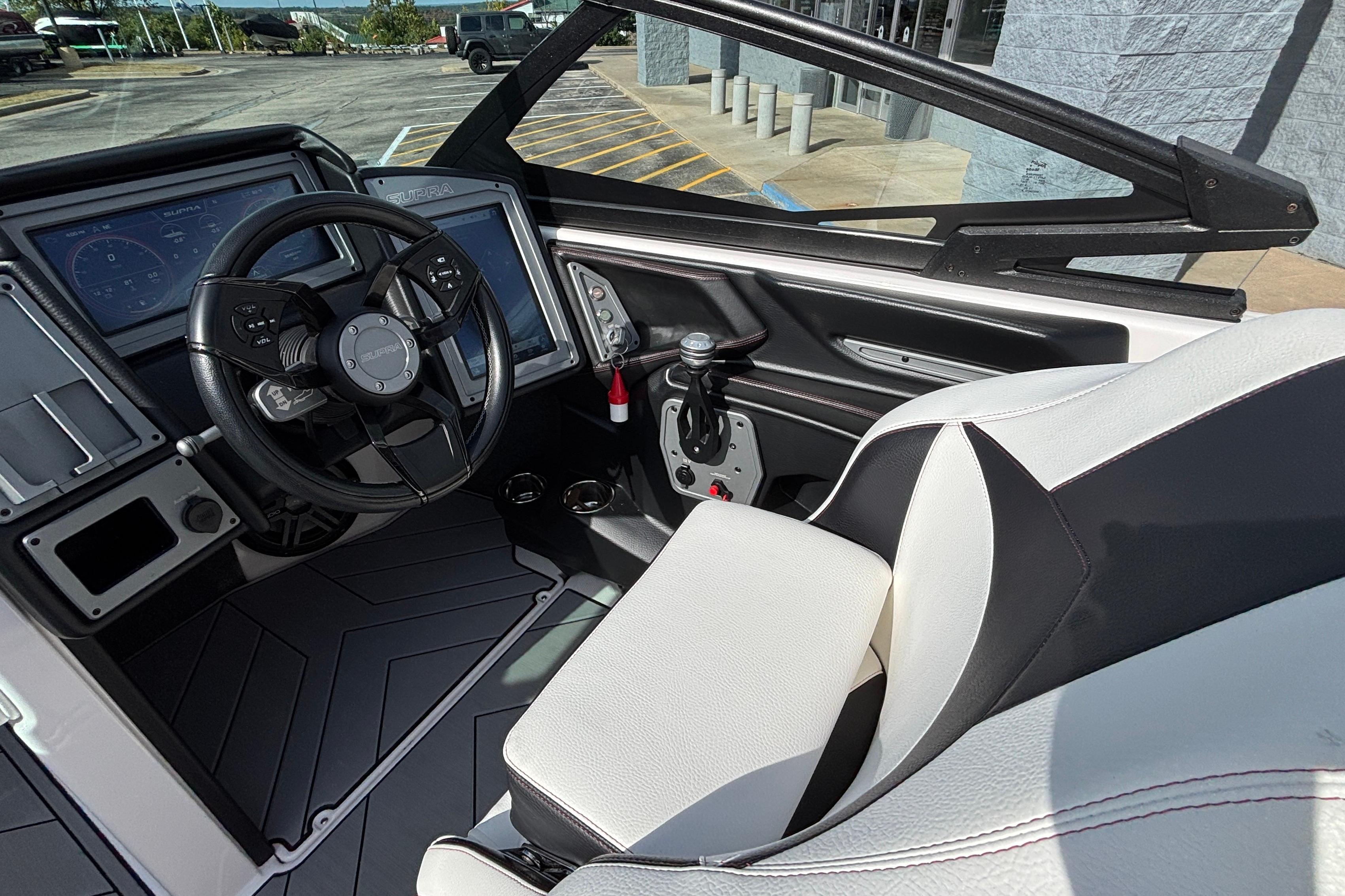 2019 Supra SL 450 boat interior with steering wheel and dashboard controls.