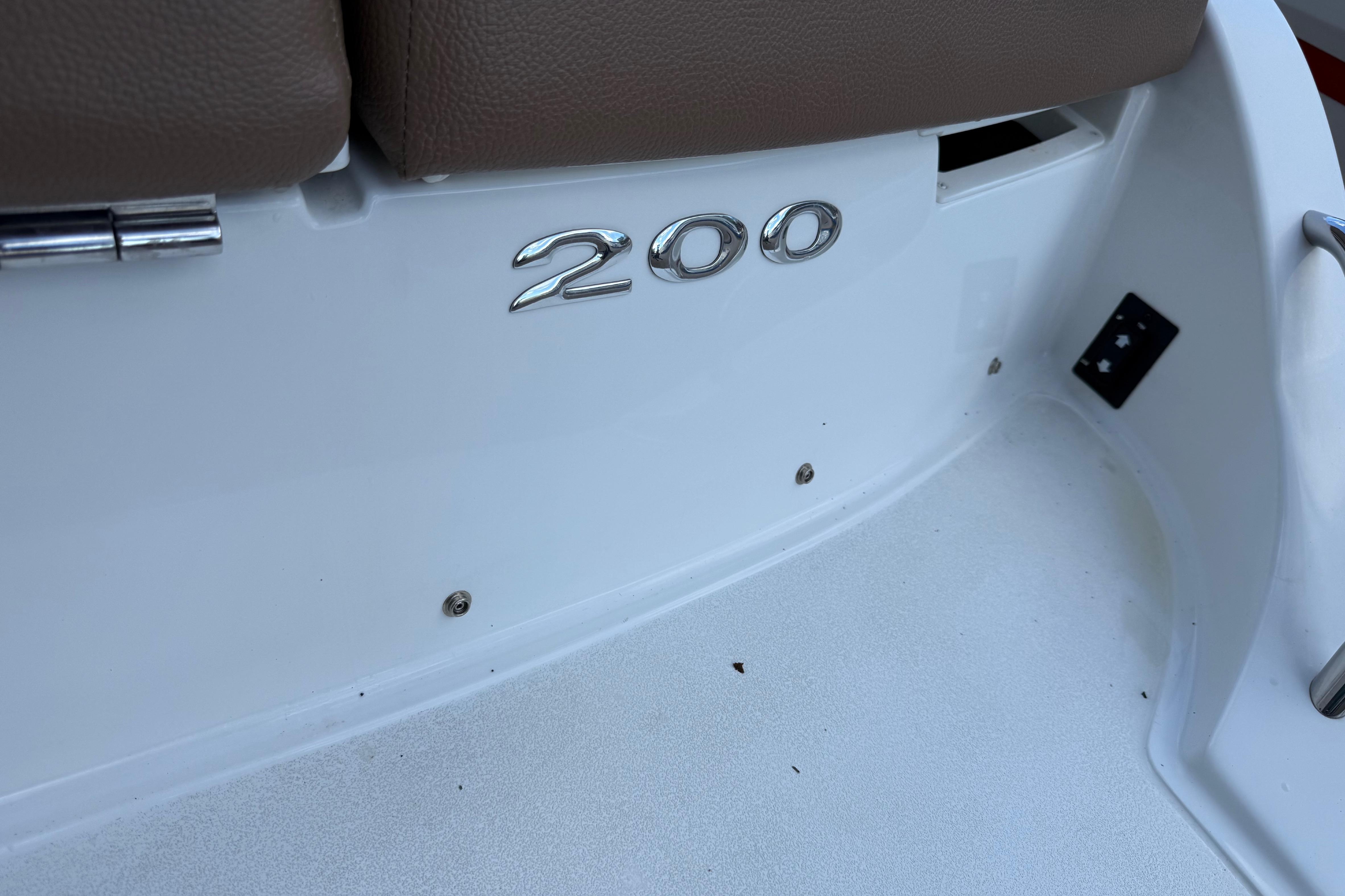 2015 Cobalt 200 boat interior with brown seating and model emblem.