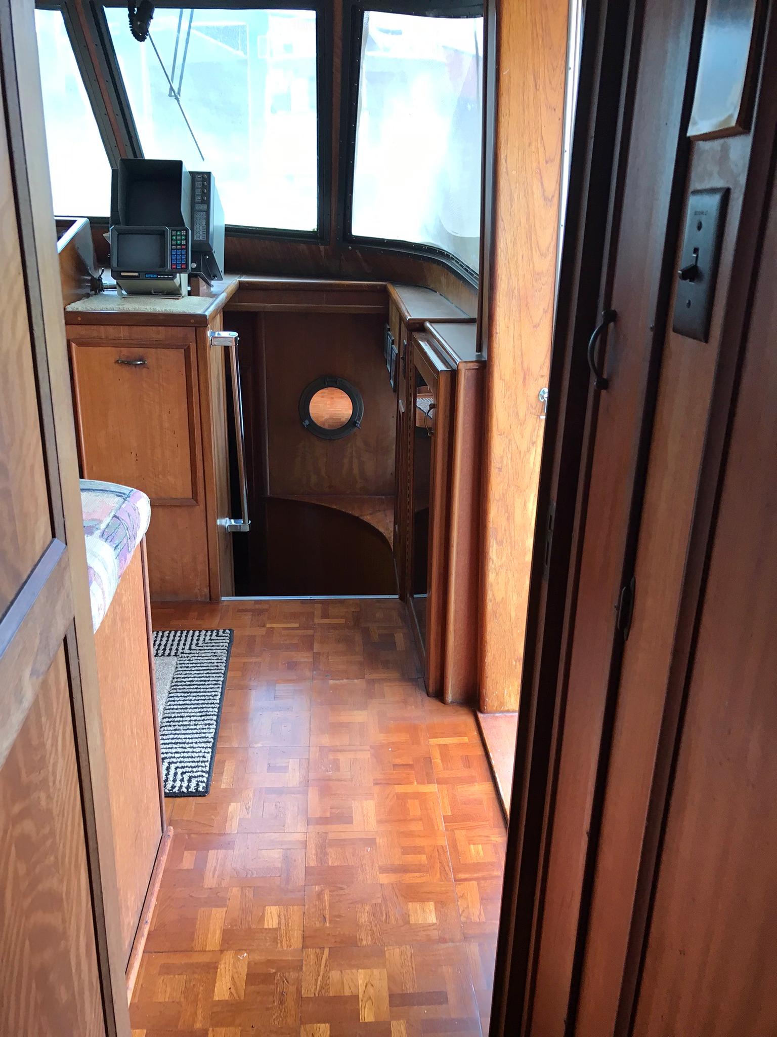 1978 Hatteras 58 MY yacht interior with wood paneling and navigation equipment.