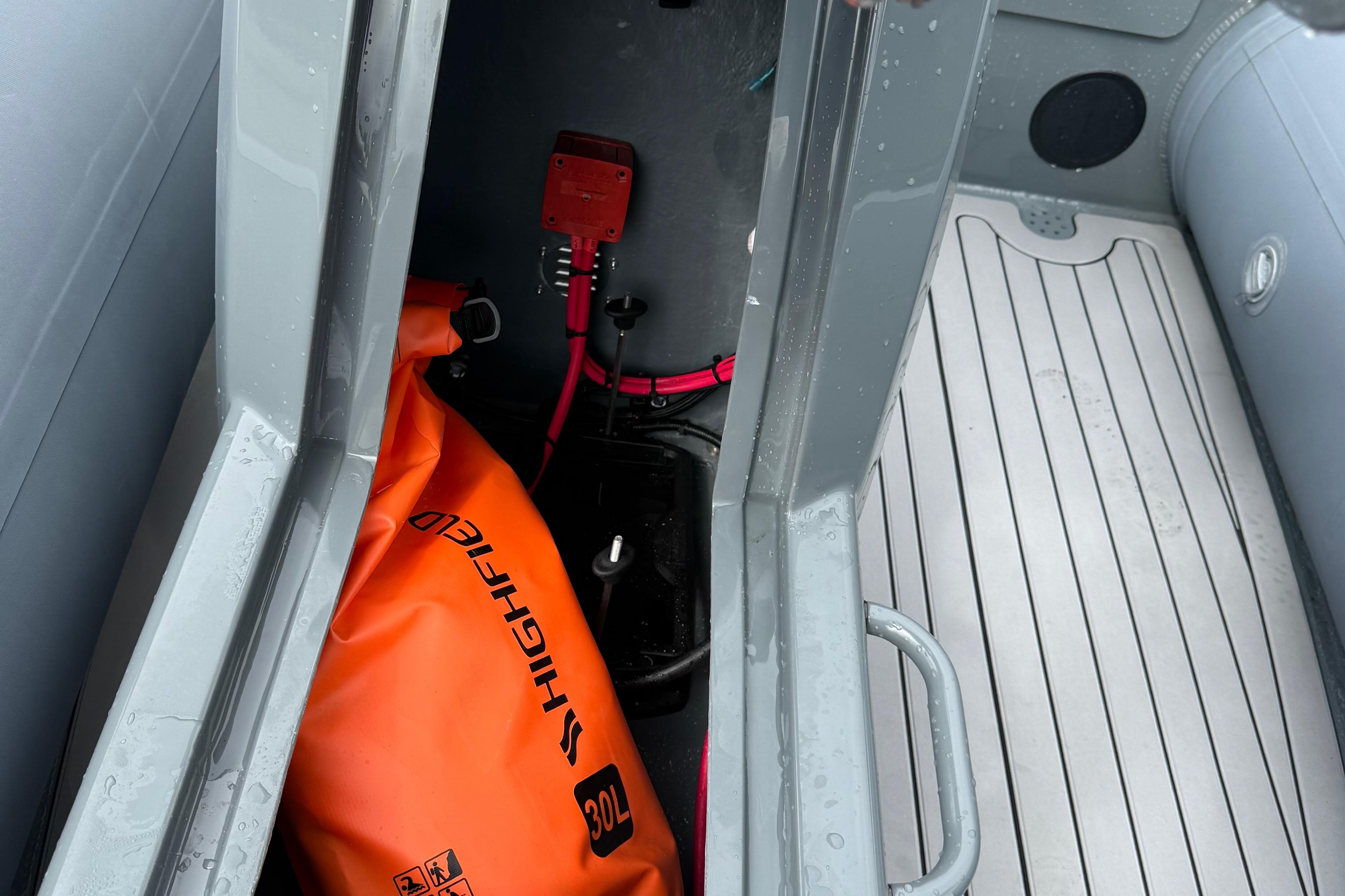 Interior view of 2025 Highfield Sport 420 boat with orange 30L storage bag.