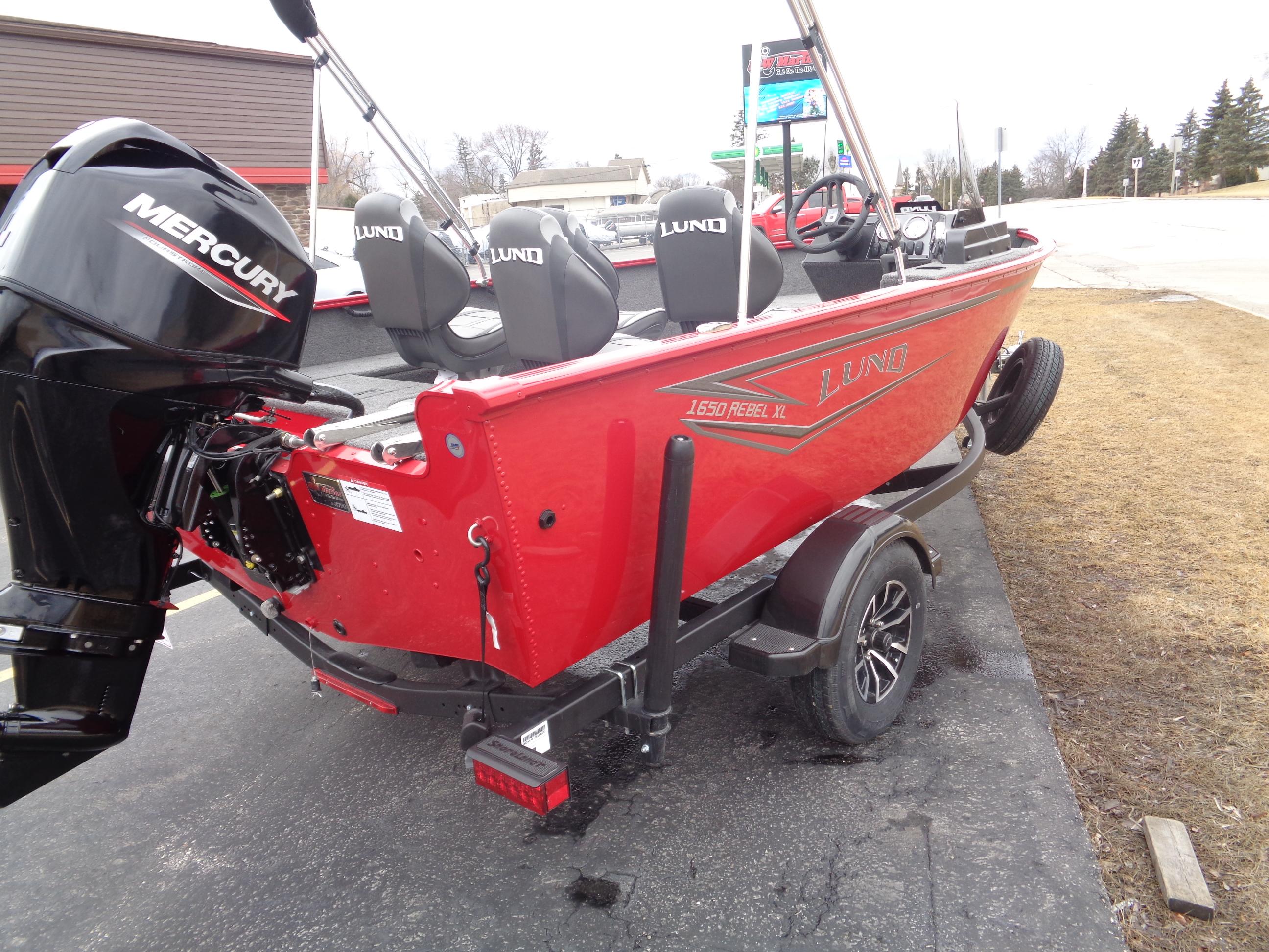 2025 Lund 1650 Rebel XL SS boat with Mercury engine, red exterior, parked on trailer.