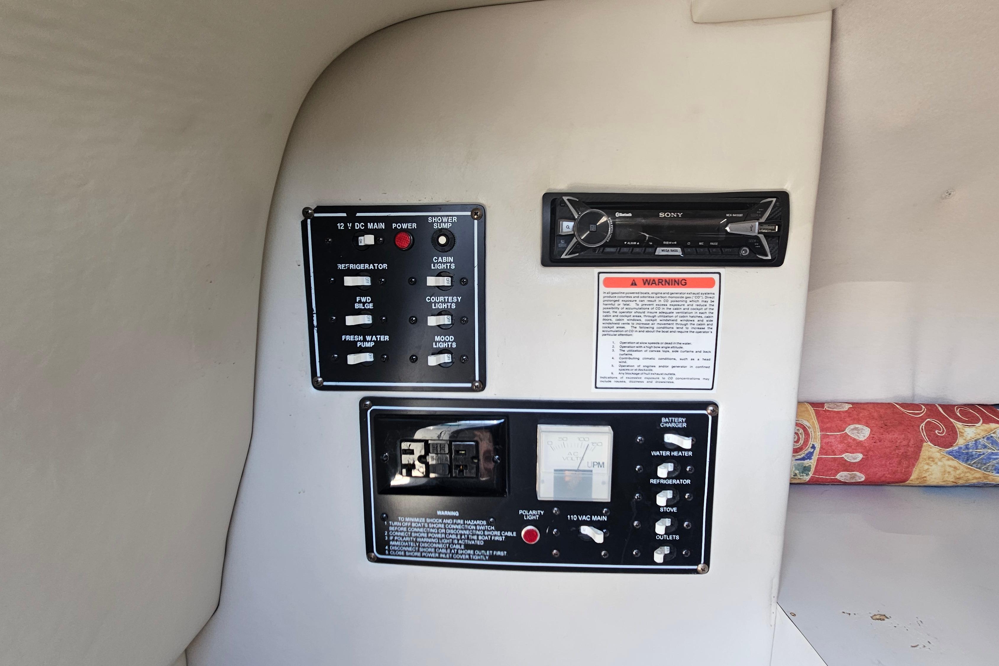 Control panel inside 2000 Crownline 242 CR boat, featuring switches and a Sony stereo.