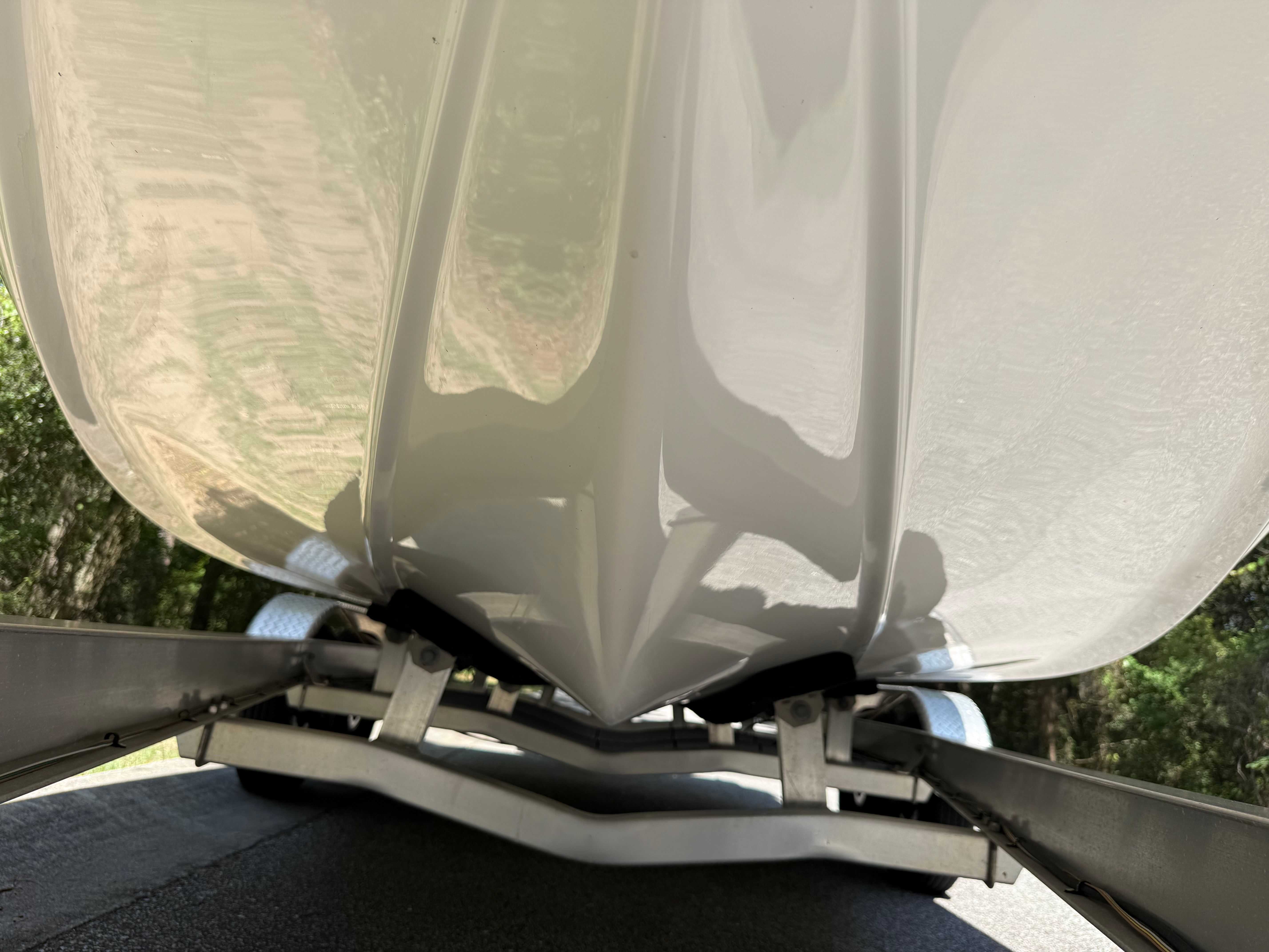 Close-up of the hull of a Tidewater 2210 Carolina Bay boat on a trailer.