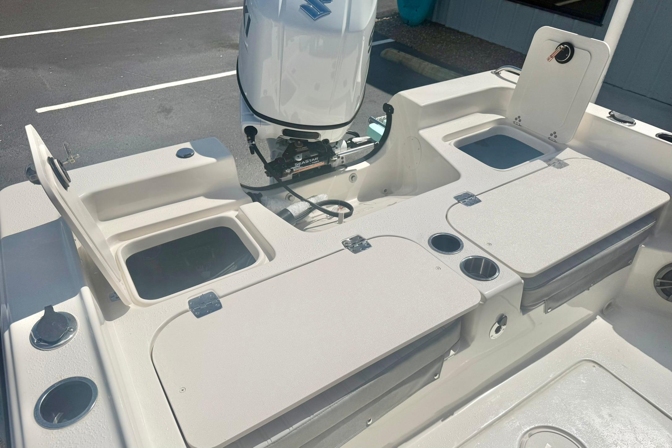 2026 Carolina Skiff 21 Ultra Elite boat interior with storage compartments and motor.