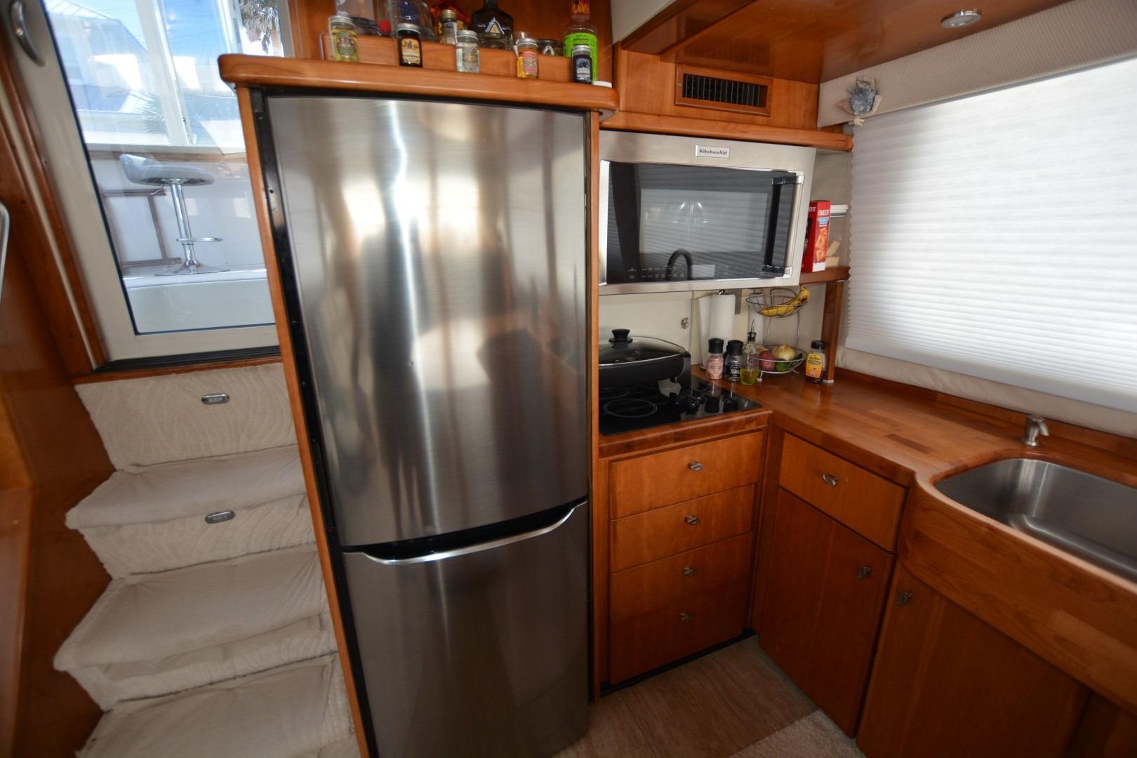 Kitchen area of 2000 Carver 504 Cockpit Motor Yacht with stainless steel appliances.