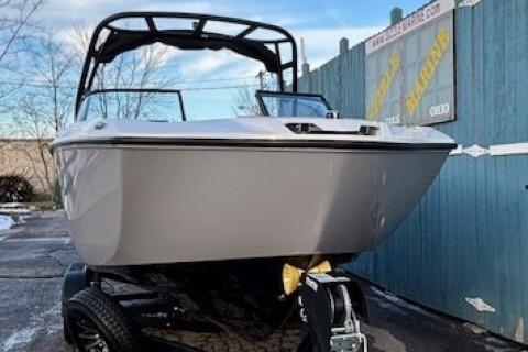 2026 Yamaha Boats AR250 on trailer, parked outdoors near a blue fence.