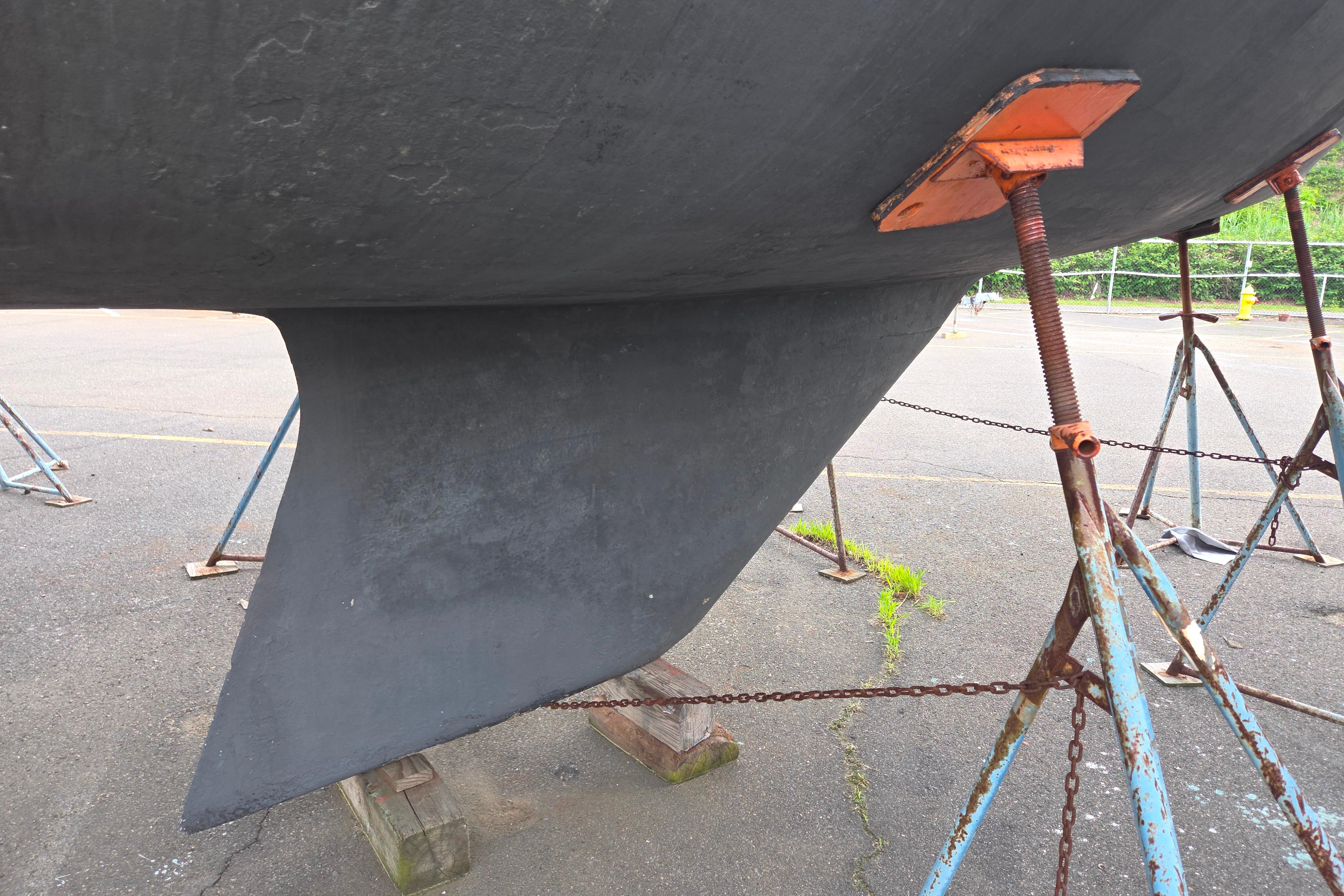 Catalina 355 sailboat keel supported by stands, 1986 model, in a boatyard.
