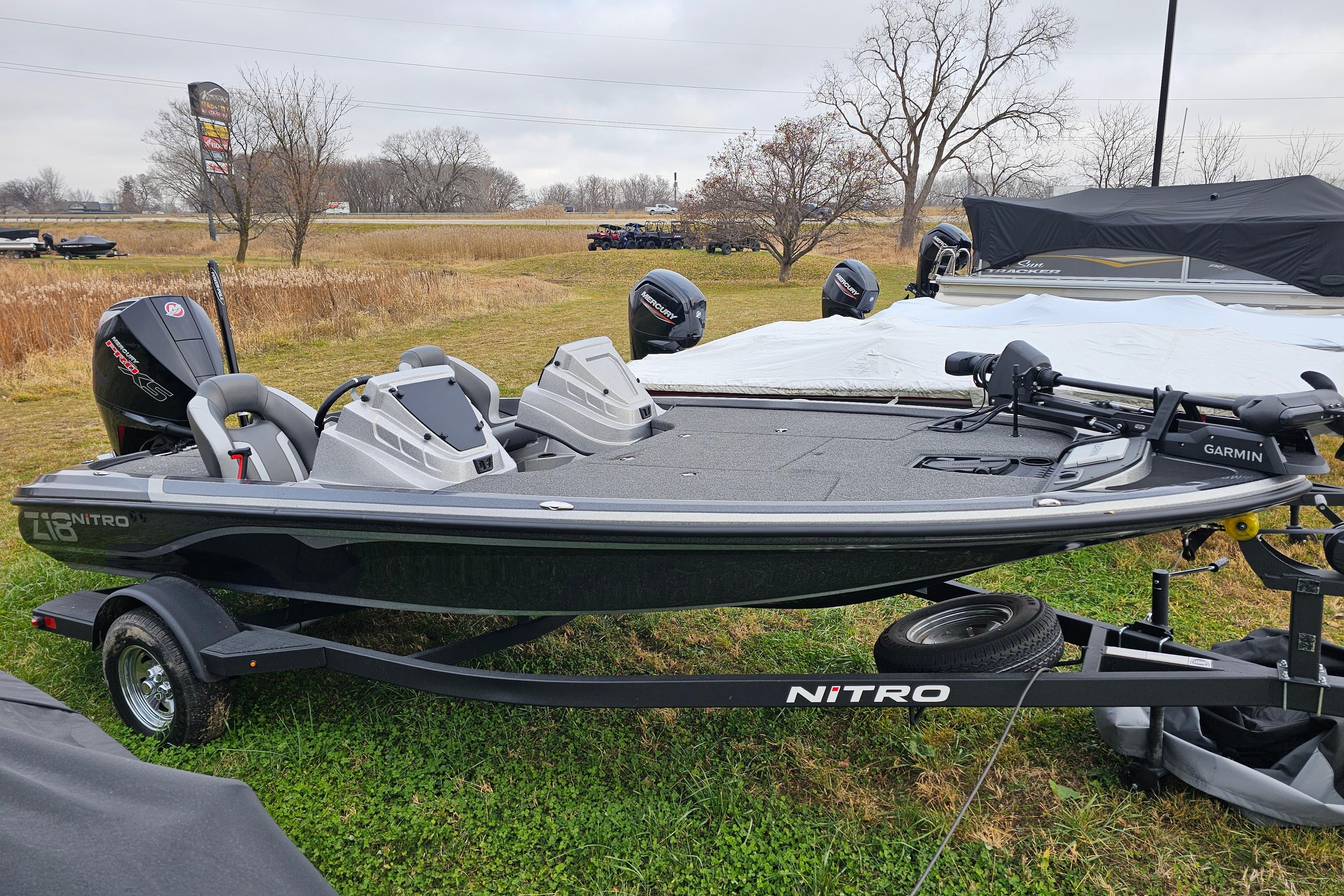 2025 Nitro Z18 Pro fishing boat on trailer, parked on grassy field.