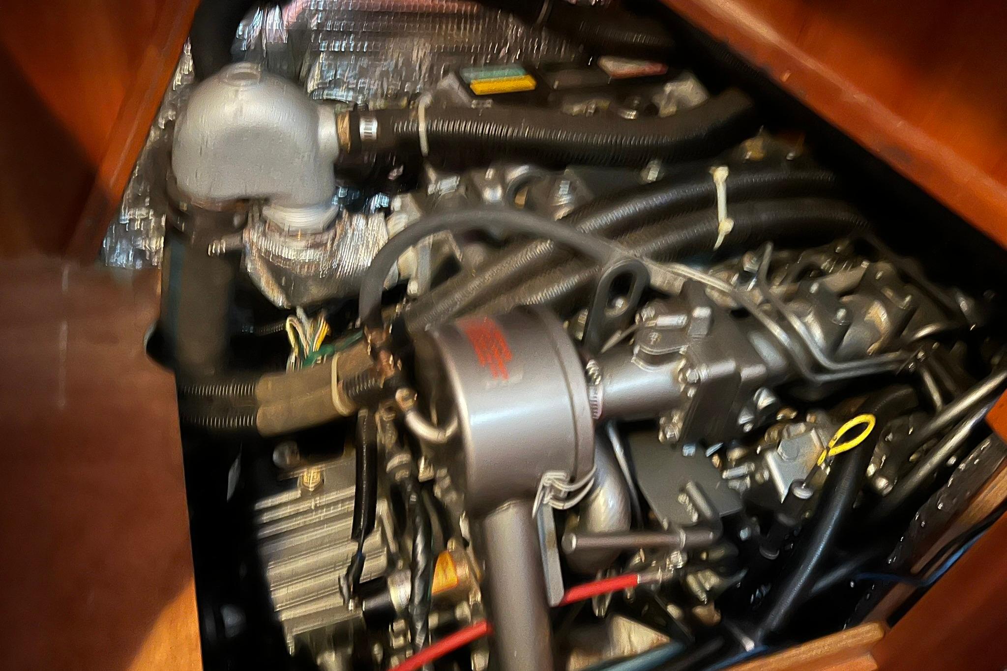 Engine compartment of a 1998 Sabre 362 sailboat, showcasing mechanical components and wiring.