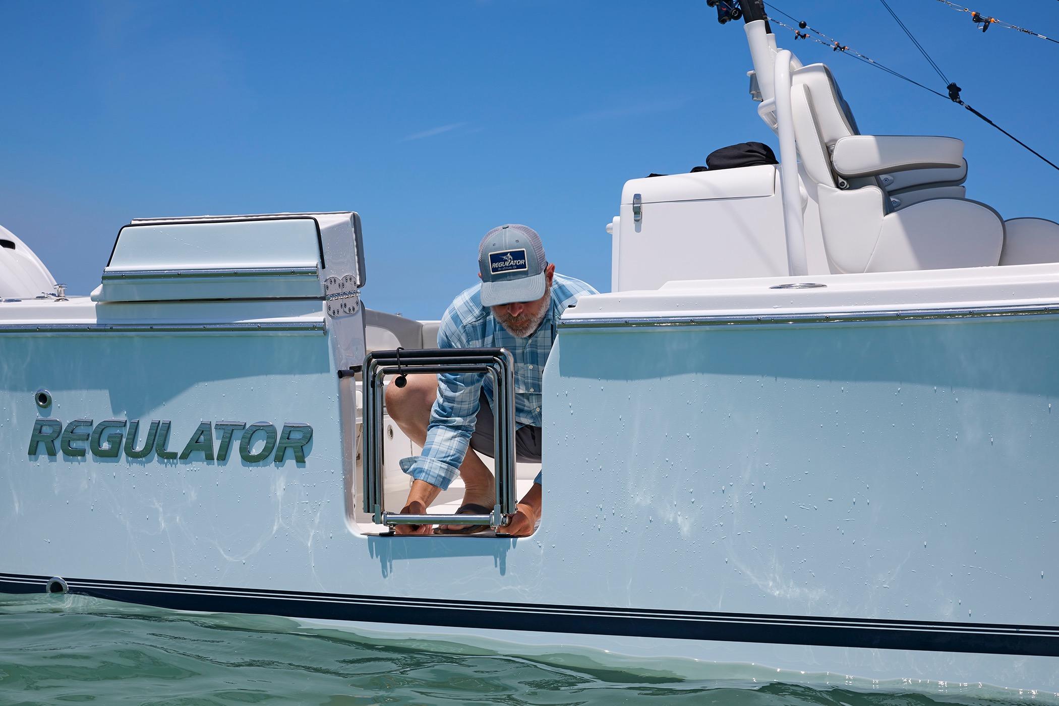 2025 Regulator 31 boat with person accessing side hatch on a sunny day.
