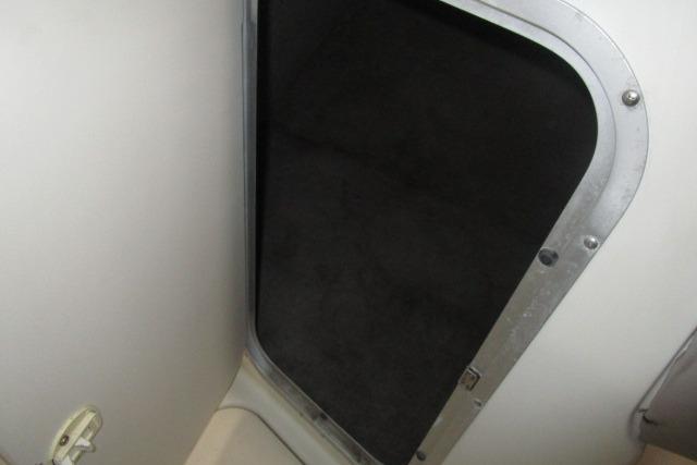 2004 Stingray 240 LR boat interior compartment with open hatch.