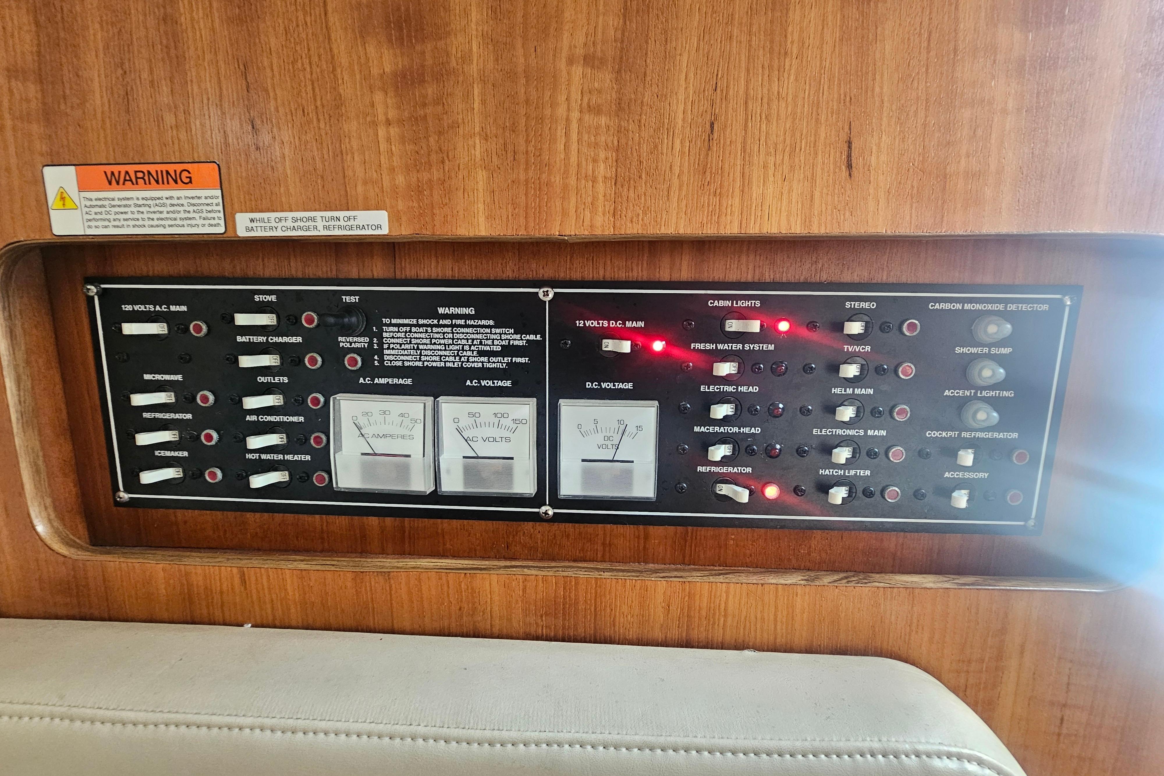Control panel of a 2001 Pursuit 3000 Express boat with various switches and gauges.