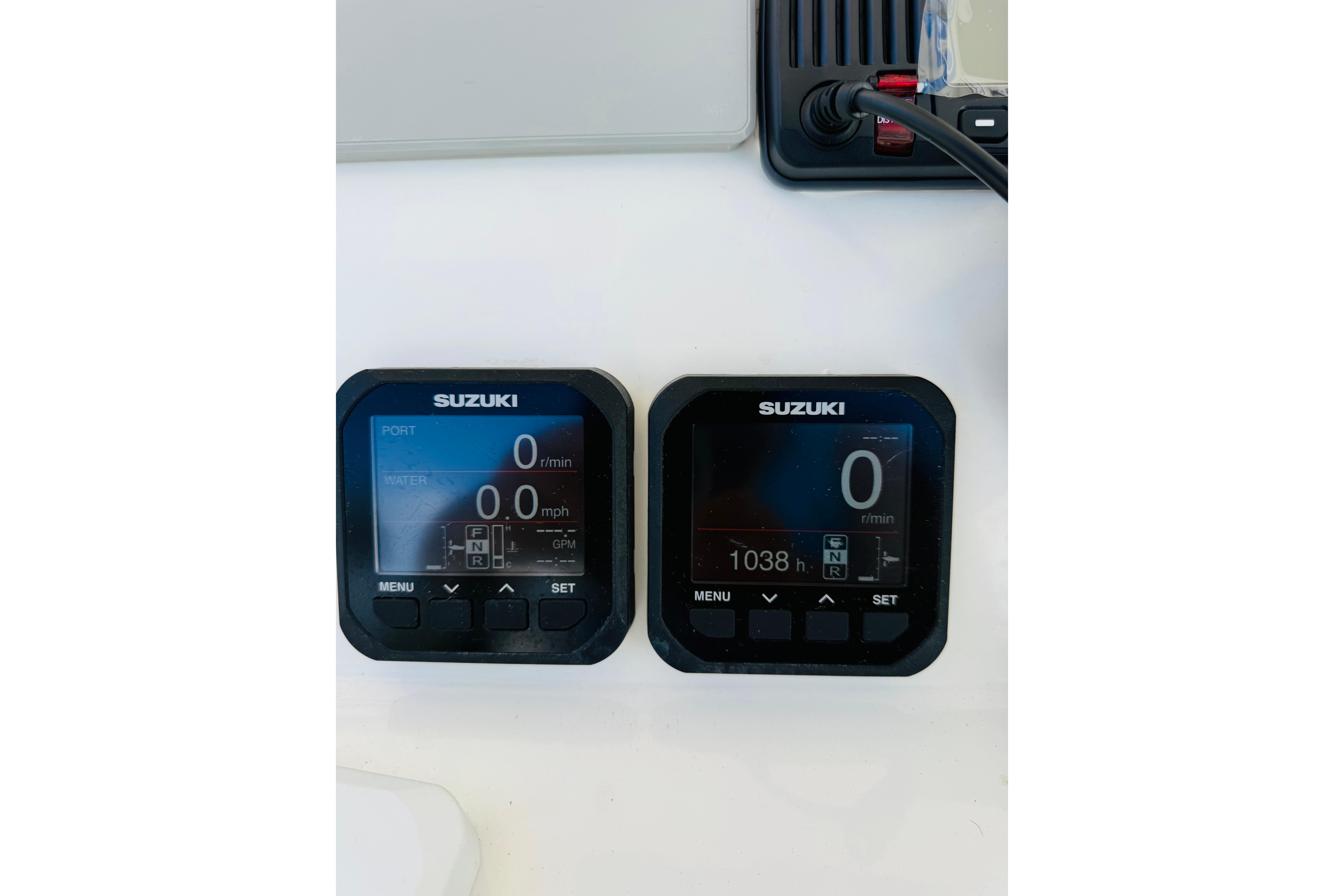 Suzuki digital gauges on a 2005 Century 3200 Center Console boat dashboard.