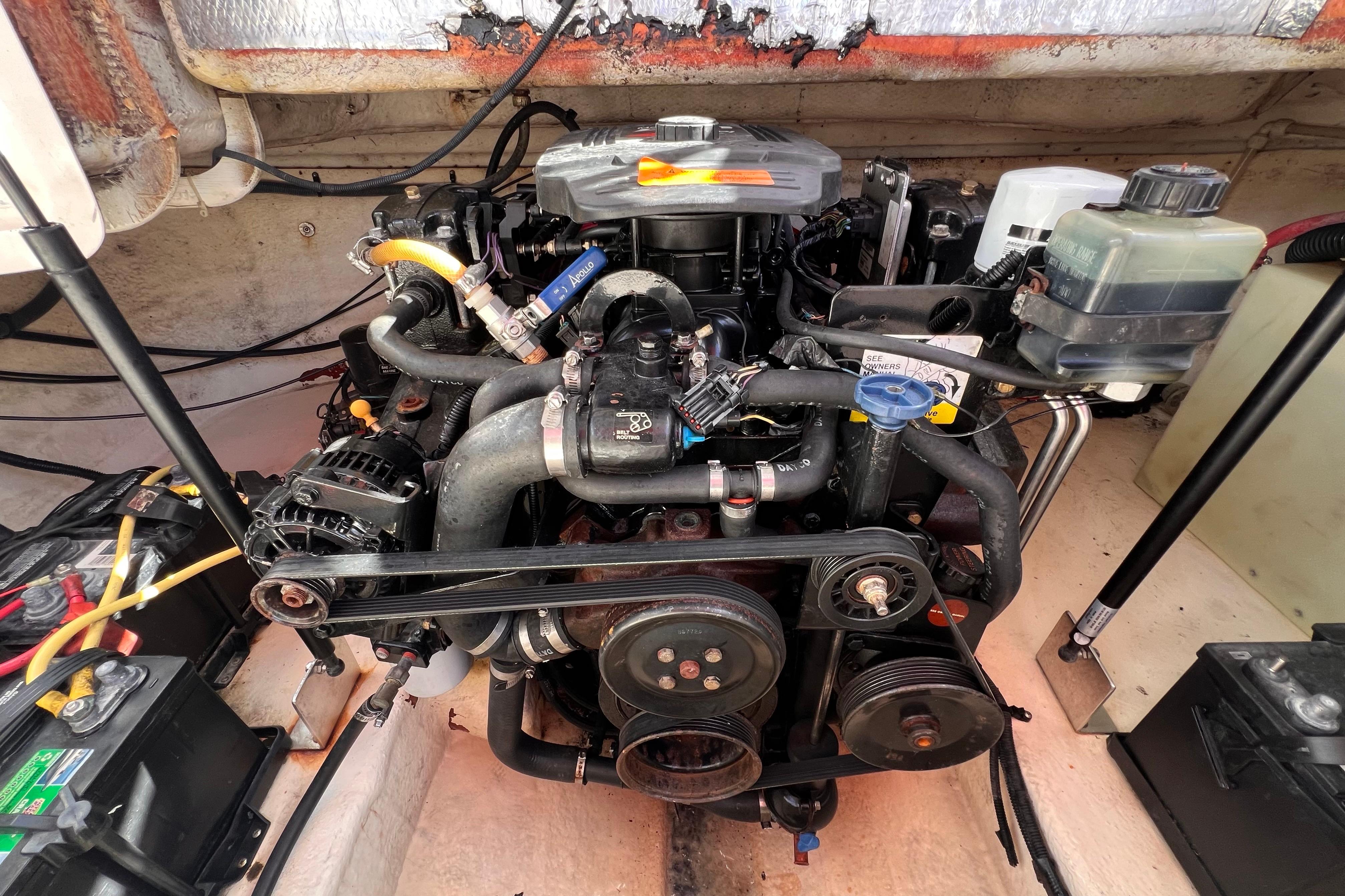 Engine compartment of a 2002 Chaparral 232 Sunesta boat, showcasing detailed components.