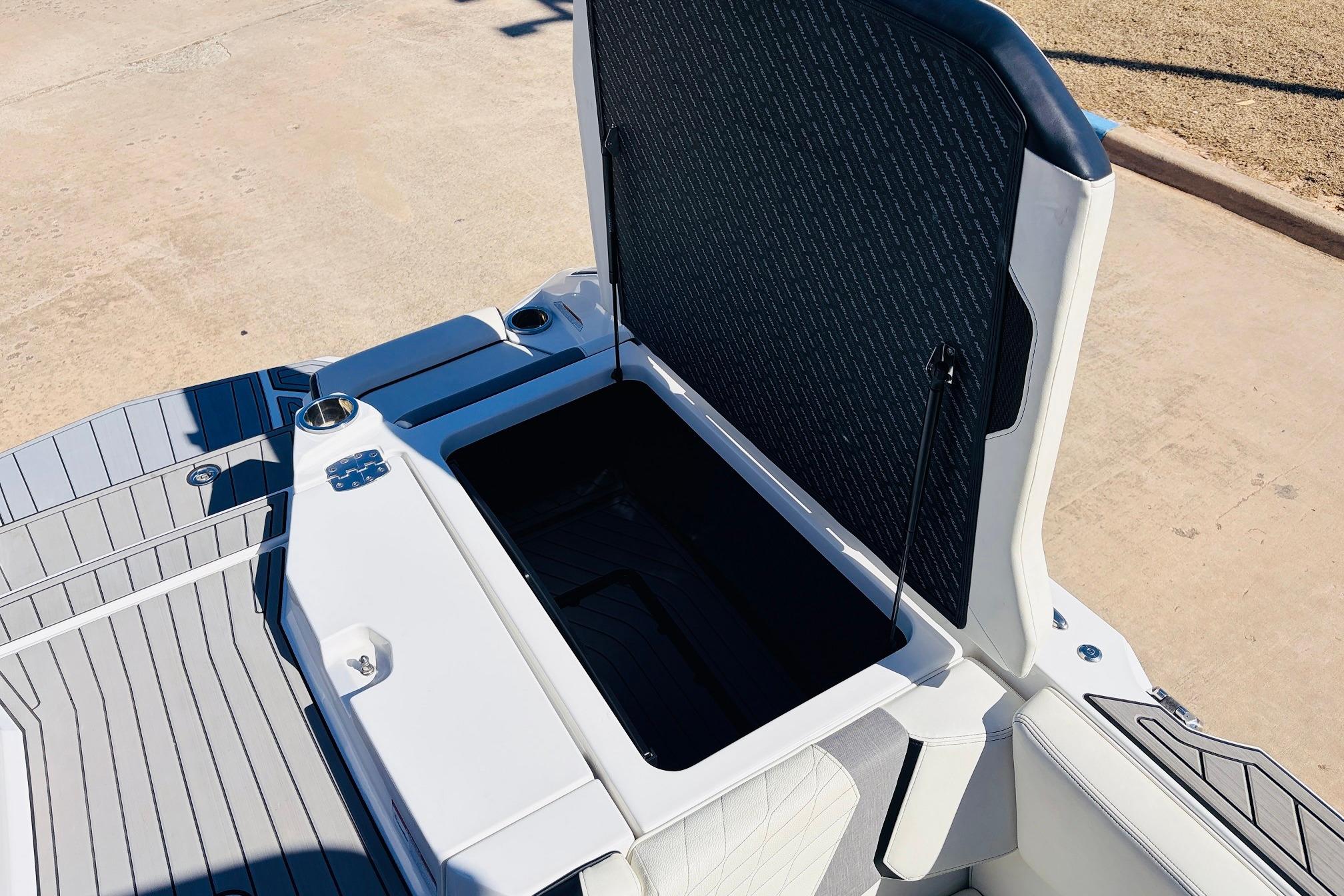 2023 Nautique Super Air Nautique G25 open storage compartment on deck.