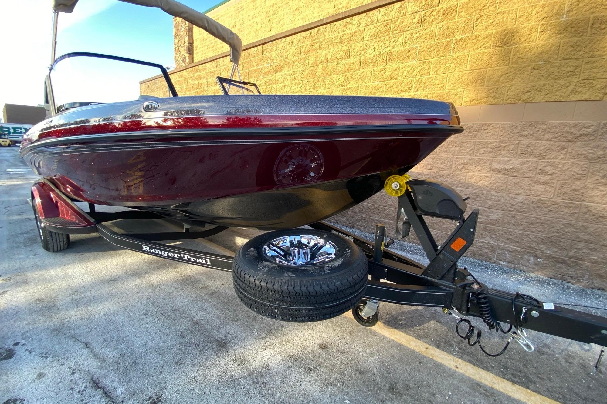 2026 Ranger 1850MS boat on trailer, parked beside a brick wall.
