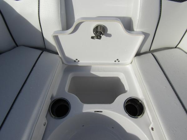 2025 Wellcraft 243 Fisherman boat seating area with cup holders and storage compartment.