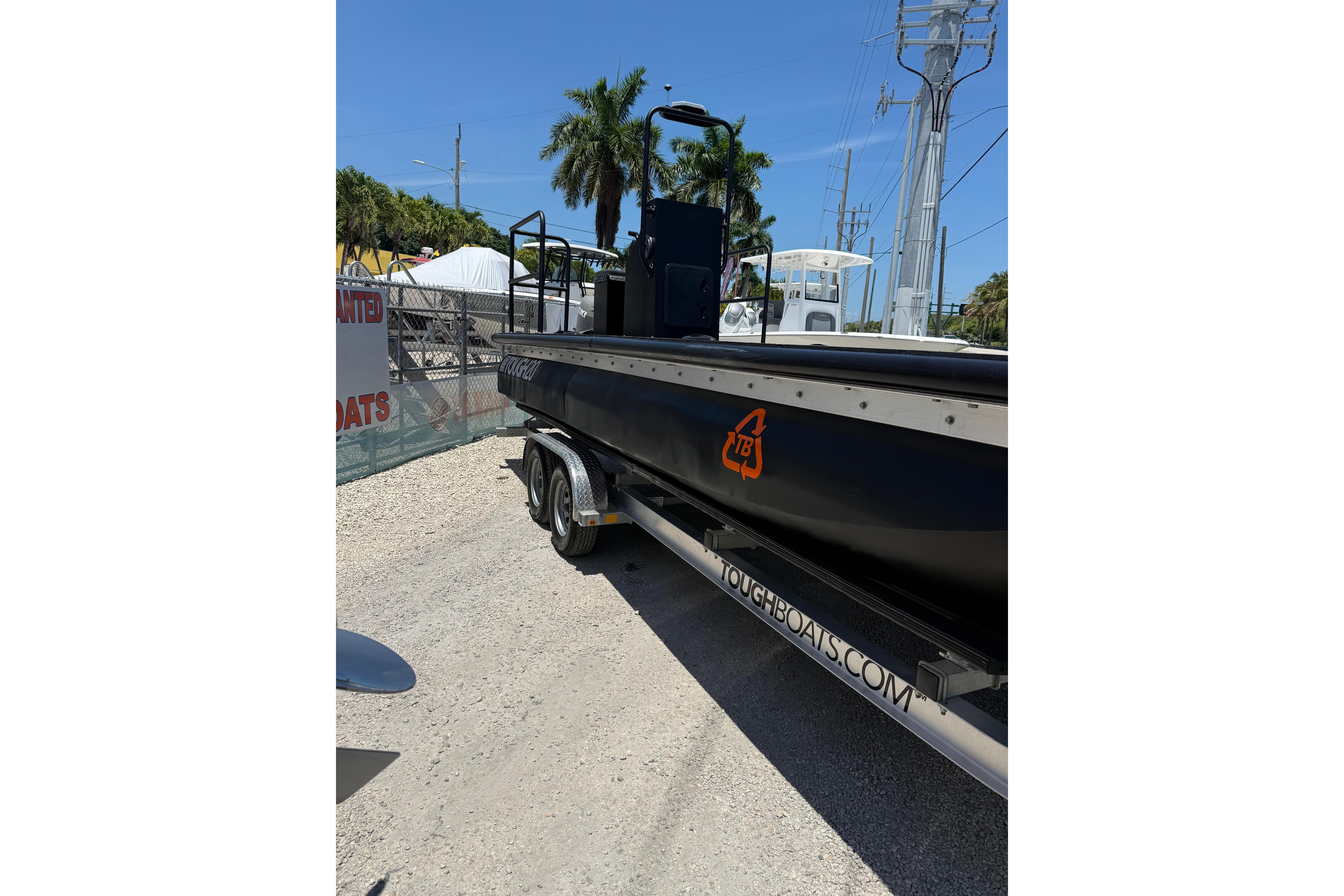 Black Tough 20 boat on trailer, parked outdoors, 2026 model.