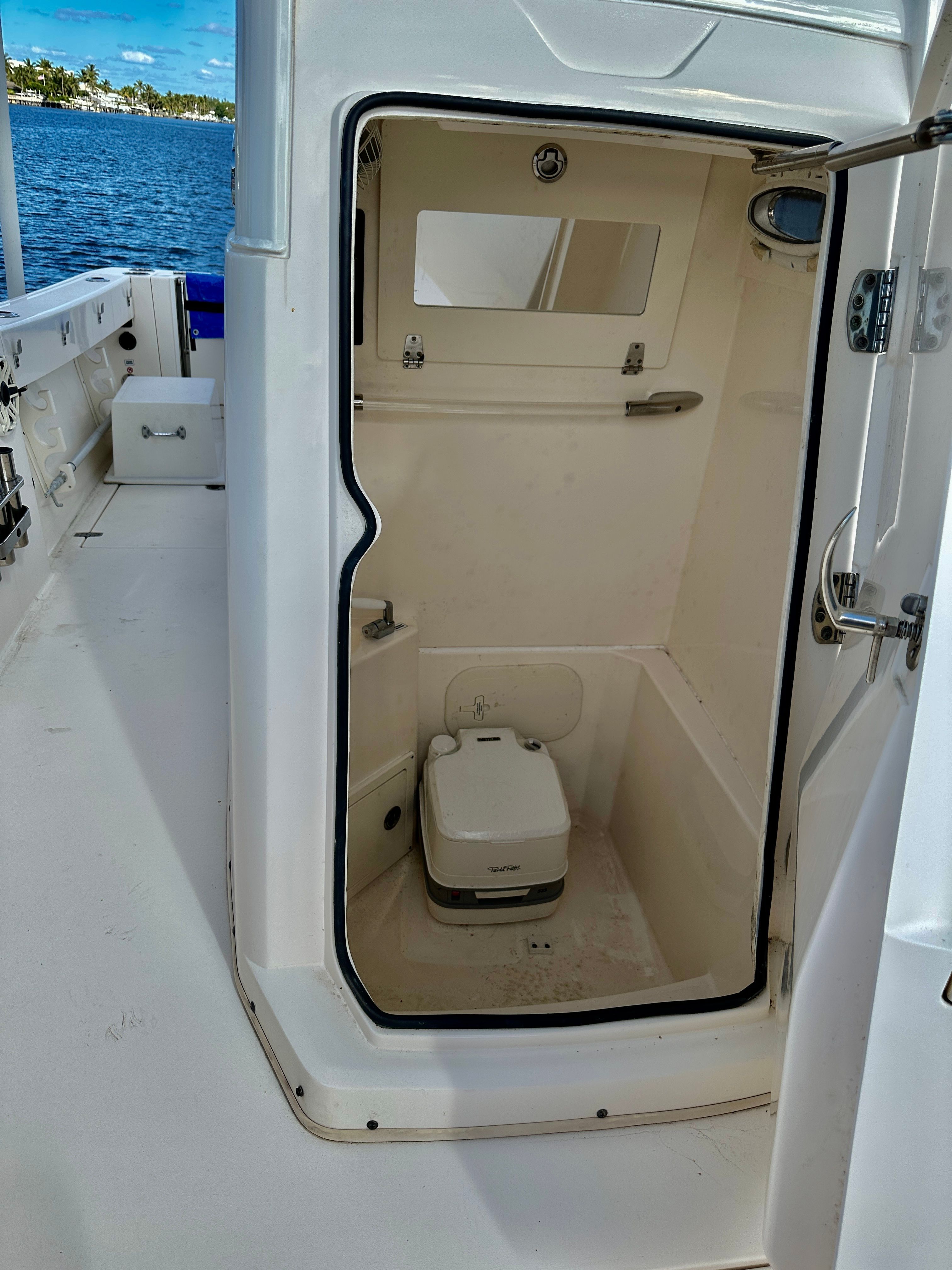 2022 Cobia 240 Center Console featuring a small toilet inside.