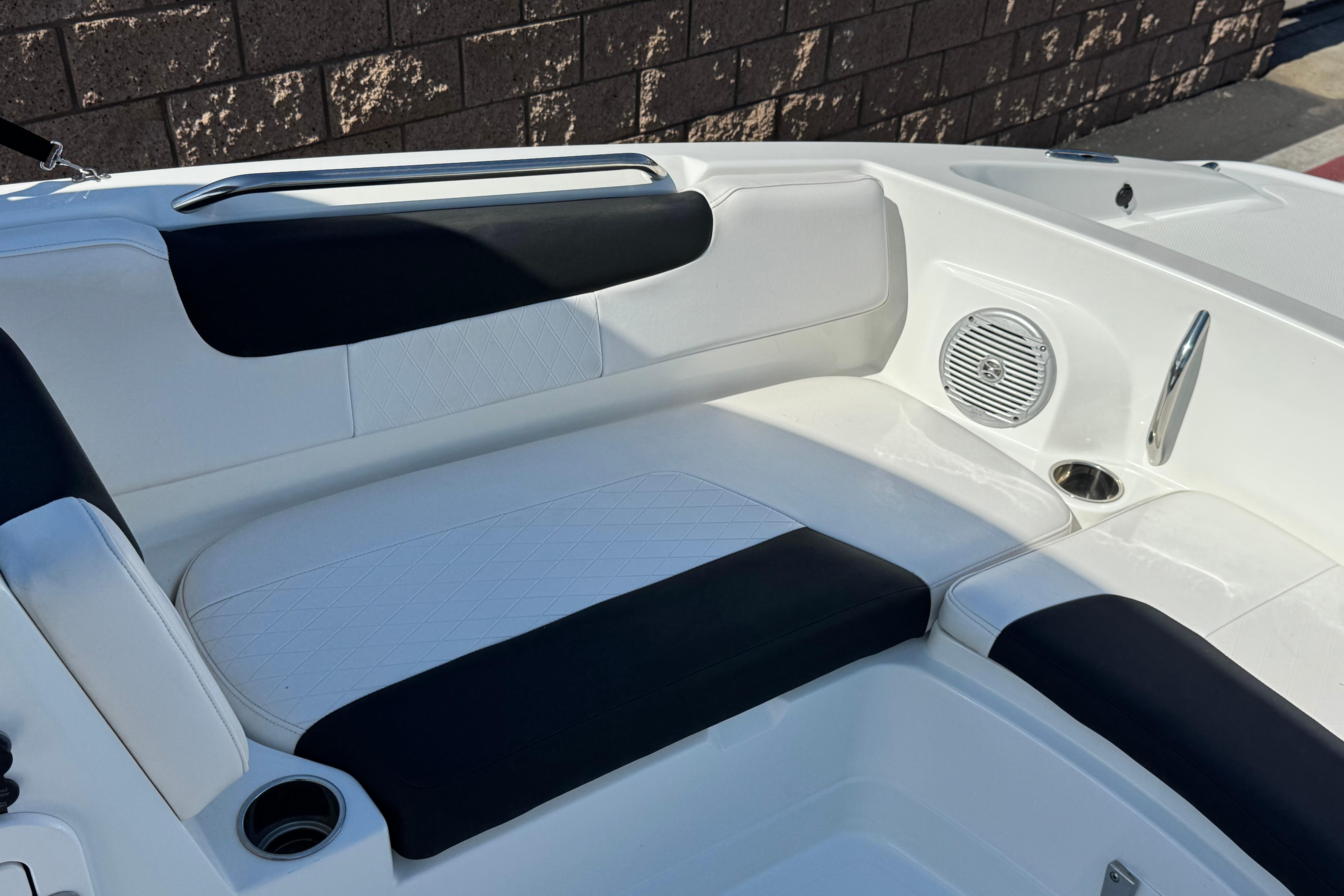 2019 Tahoe 2150 boat interior with white and black seating, cup holder, and speaker.