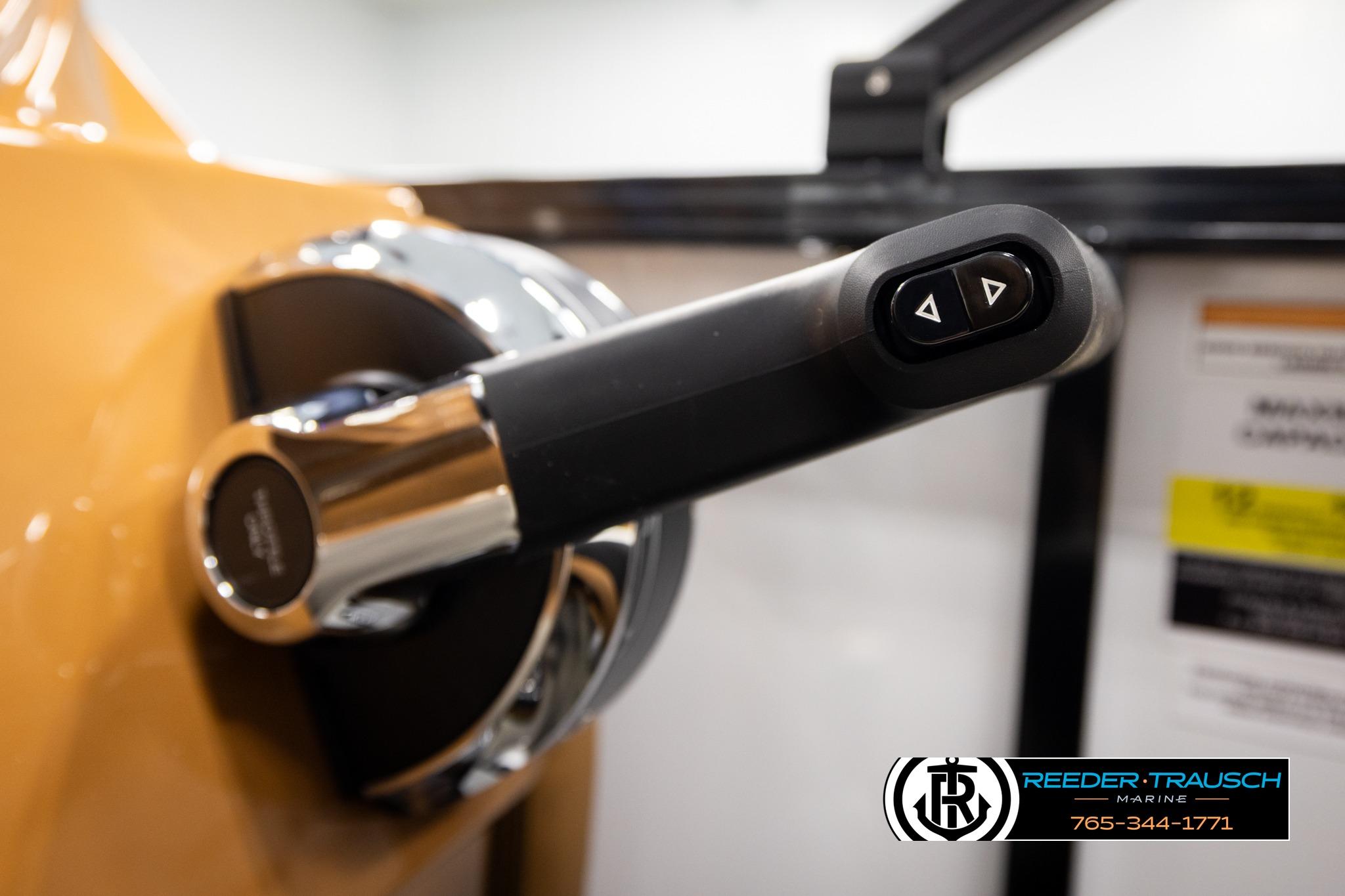 Close-up of 2026 Avalon LSZ ELW throttle control with buttons, Reeder-Trausch Marine logo visible.