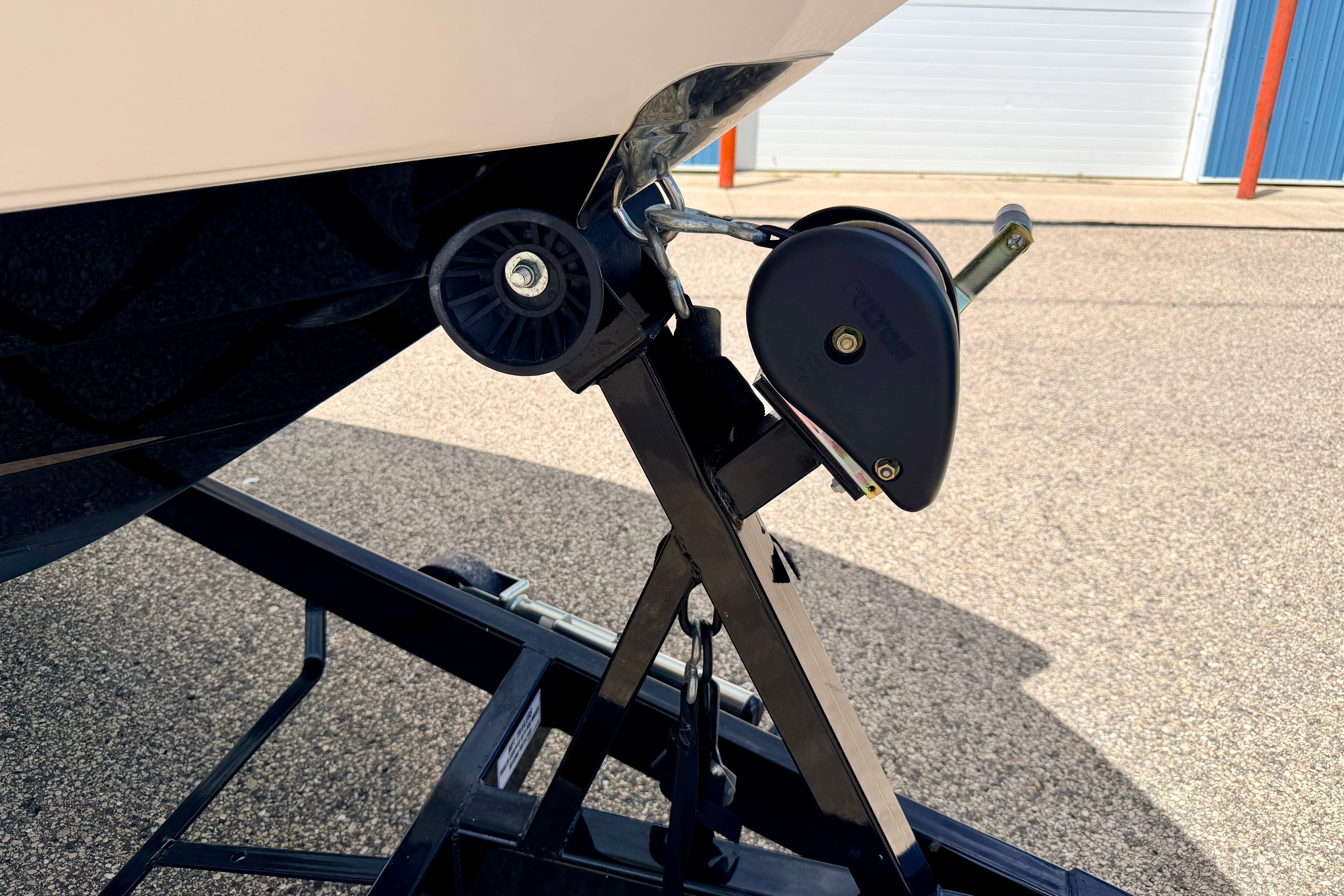 2015 Chaparral Sunesta 264 boat trailer hitch detail in a parking area.