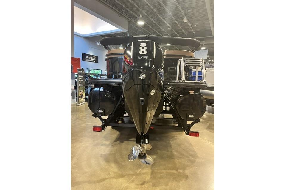 2026 Regency 230 DL boat with powerful 200 V6 engine in showroom.