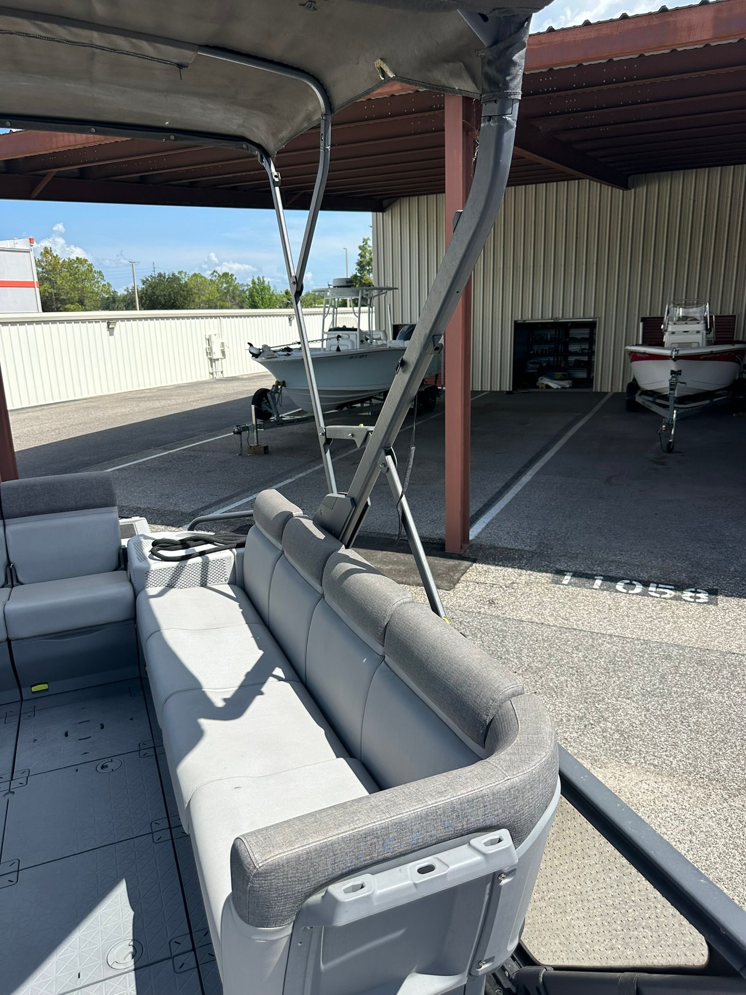 The image shows the interior of a 2023 Sea-Doo 21 SWITCH SPORT with gray seating.