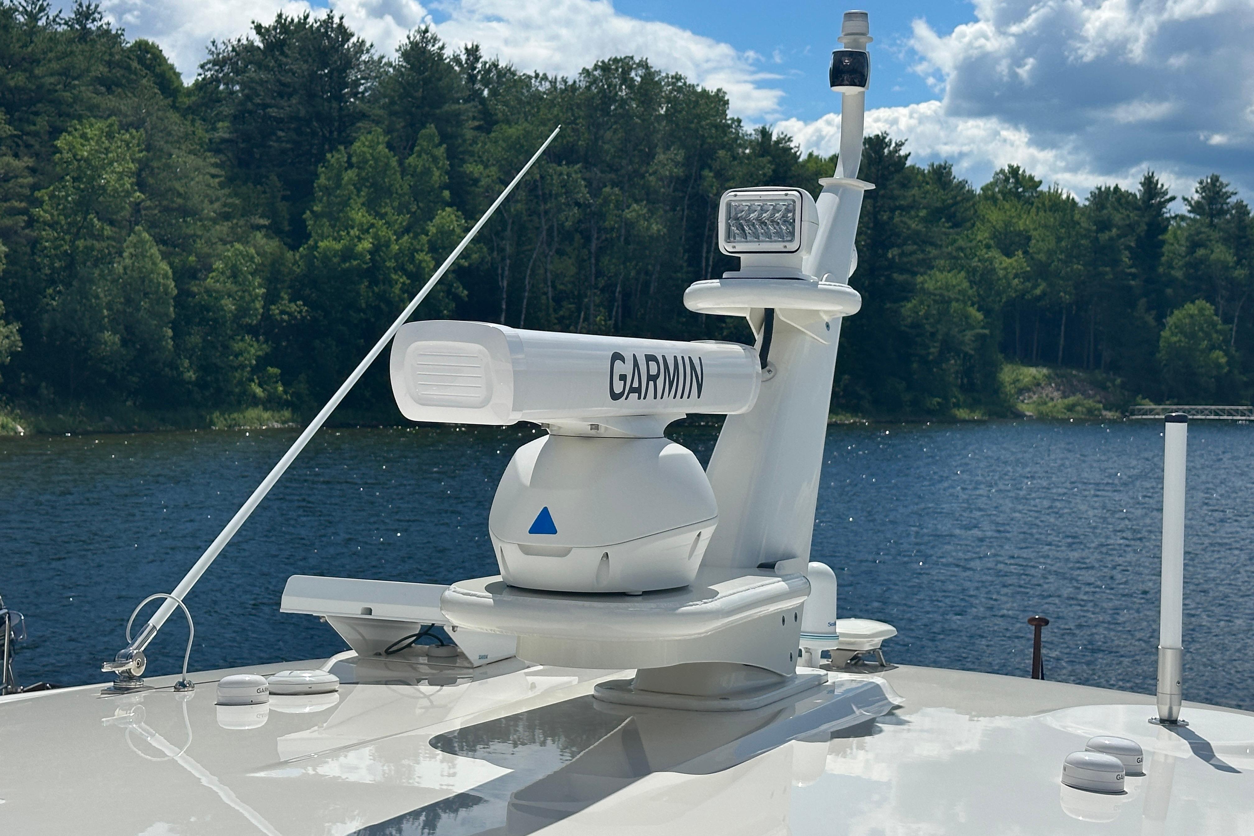 2025 Sabre 48 Salon Express with Garmin radar on a serene lake backdrop.