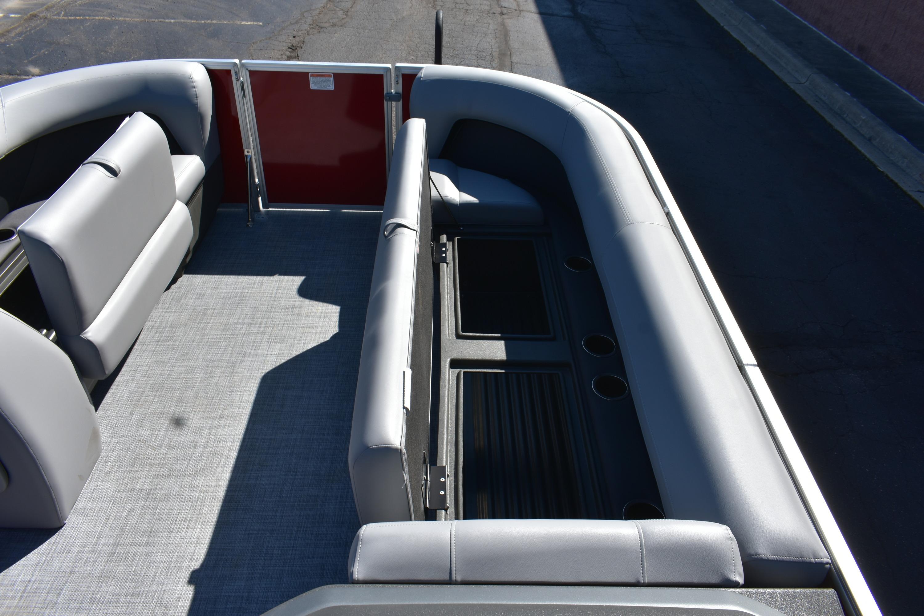 2026 Sun Tracker Party Barge 18 DLX interior with gray seating and cup holders.