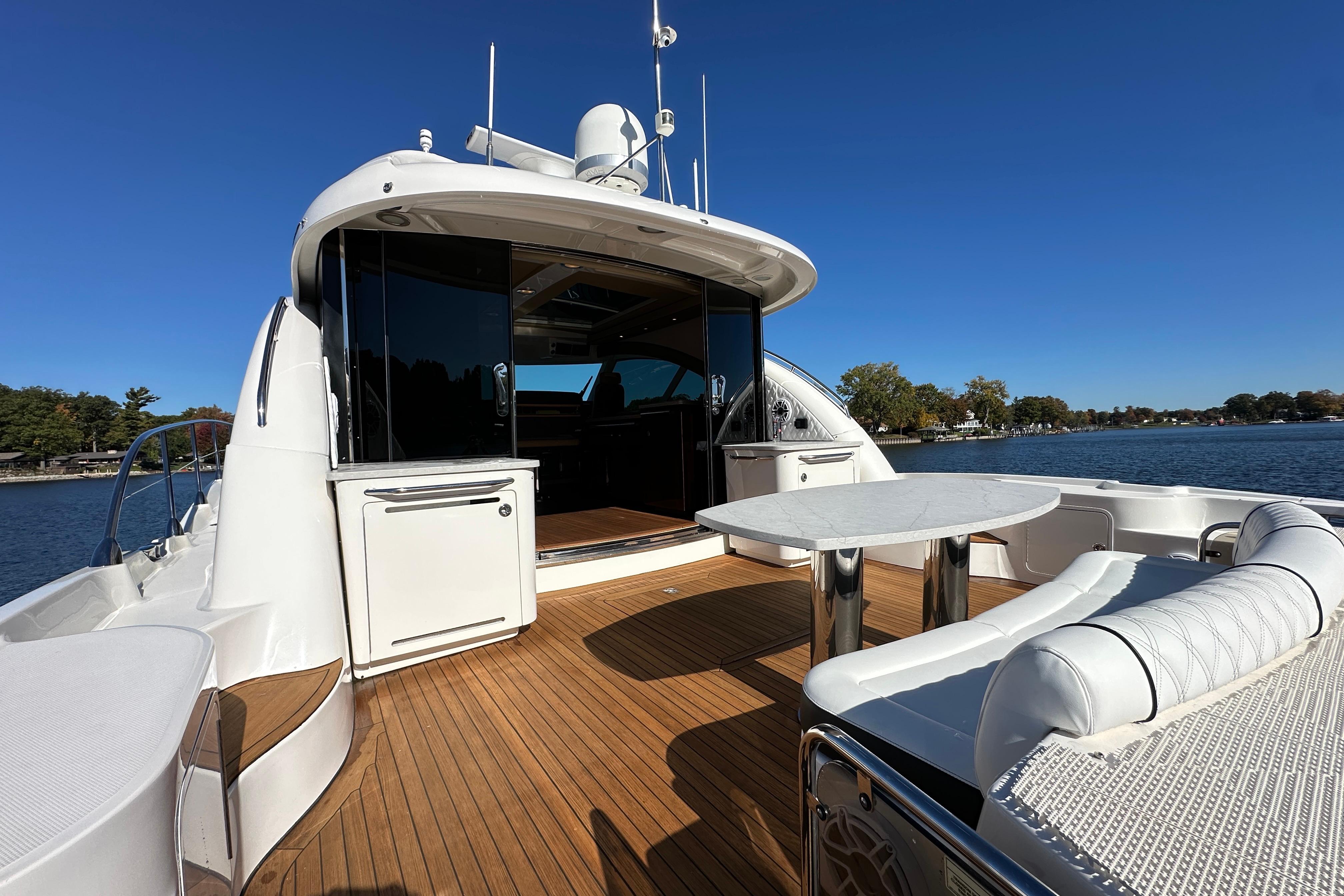 2007 Sea Ray 60 Sundancer yacht with spacious deck and seating, cruising on a sunny day.