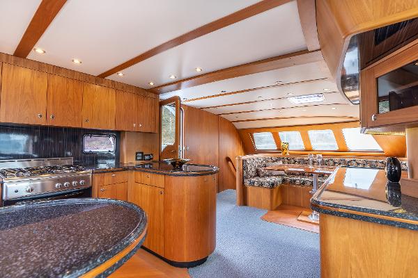 Luxurious interior of 2025 Shuttleworth 52 AeroRig yacht with modern kitchen and dining area.