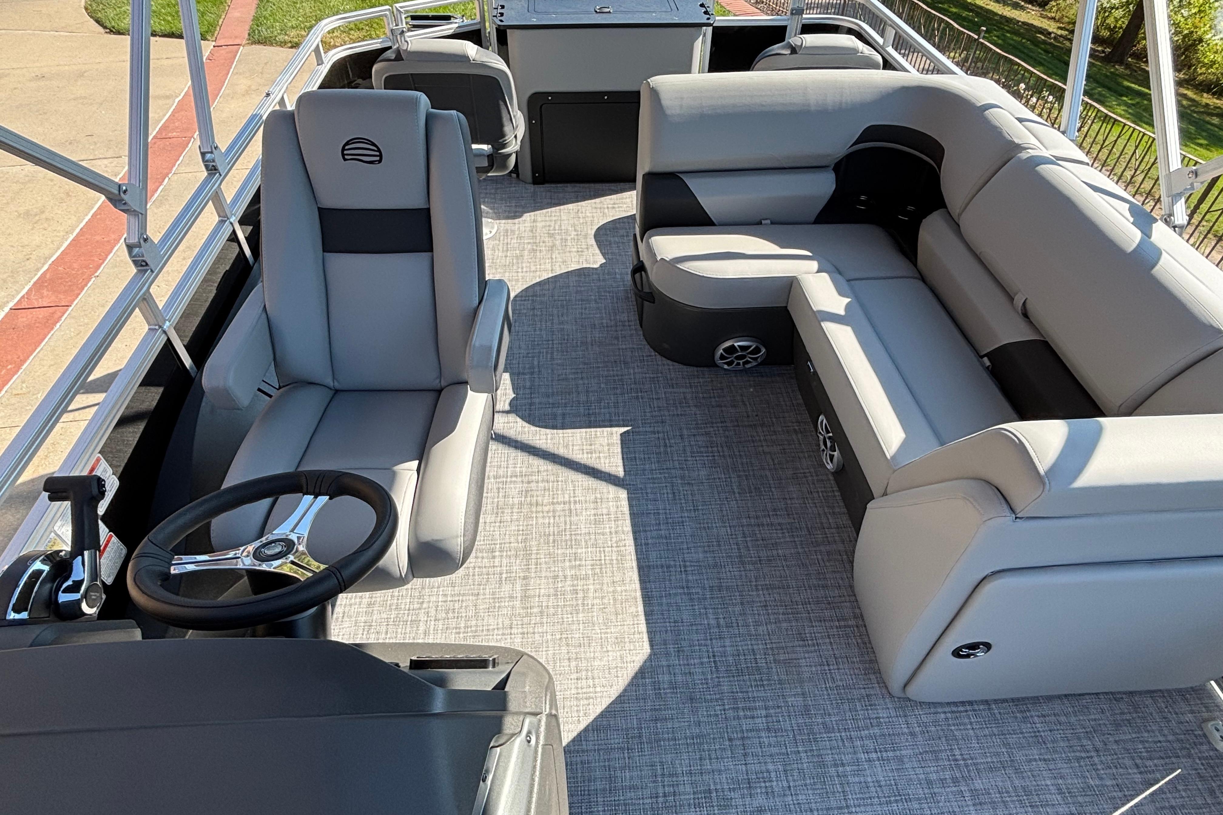2026 Sun Tracker SportFish 22 DLX interior with plush seating and steering console.