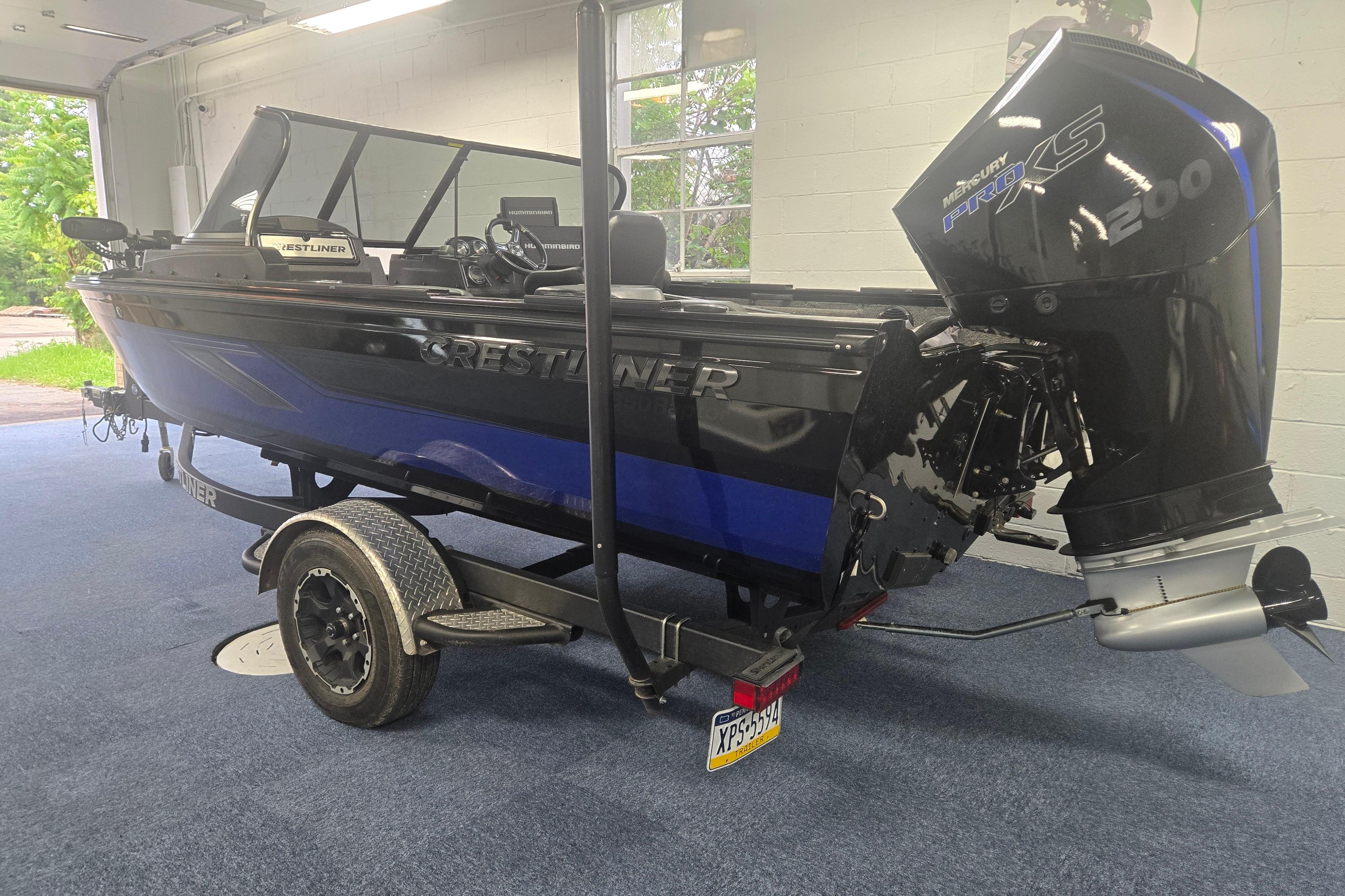 2020 Crestliner 1850 Raptor WT boat with Mercury Pro XS engine on trailer in garage.