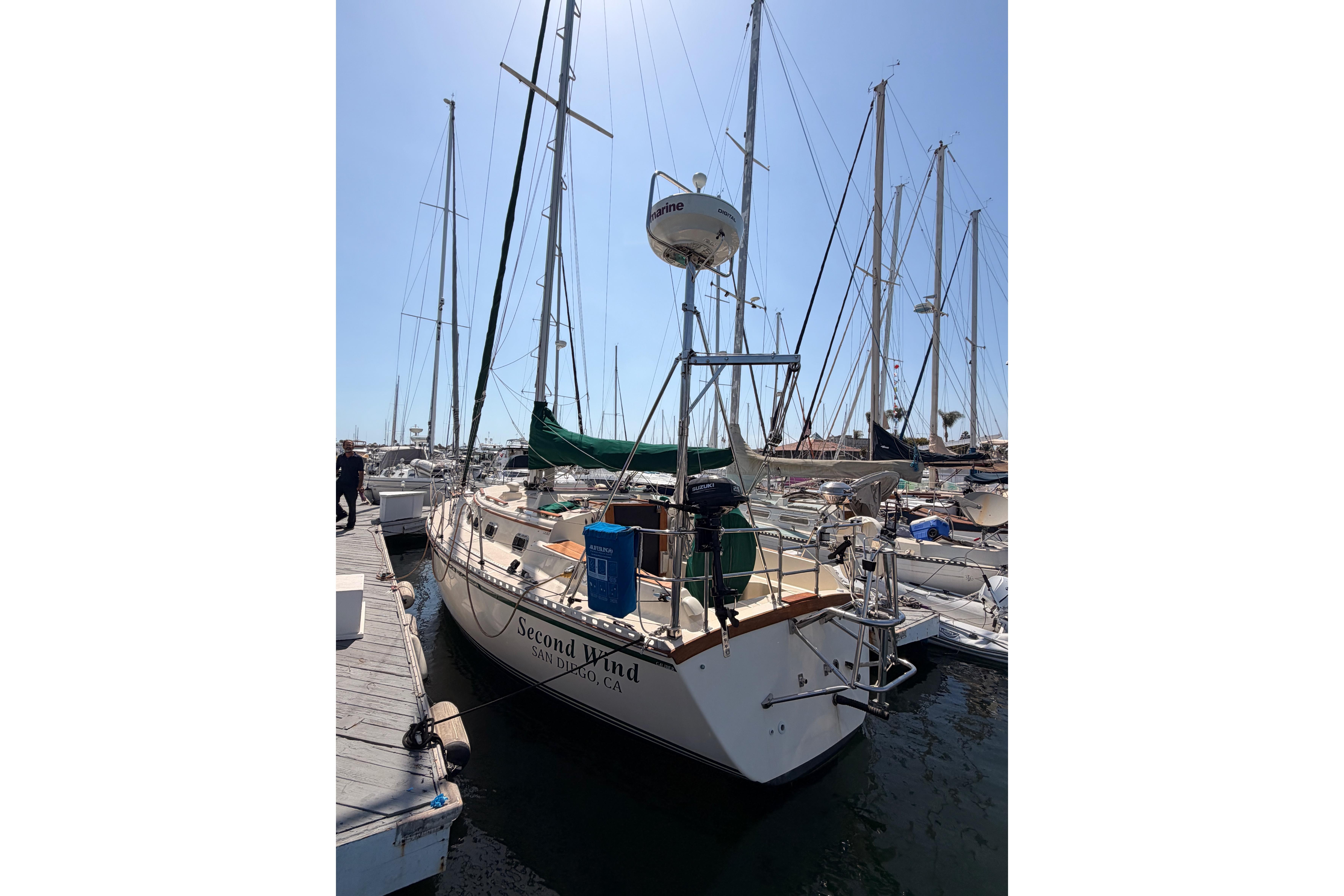 1991 Caliber 33 sailboat docked in marina, named "Second Wind," San Diego, clear sky.