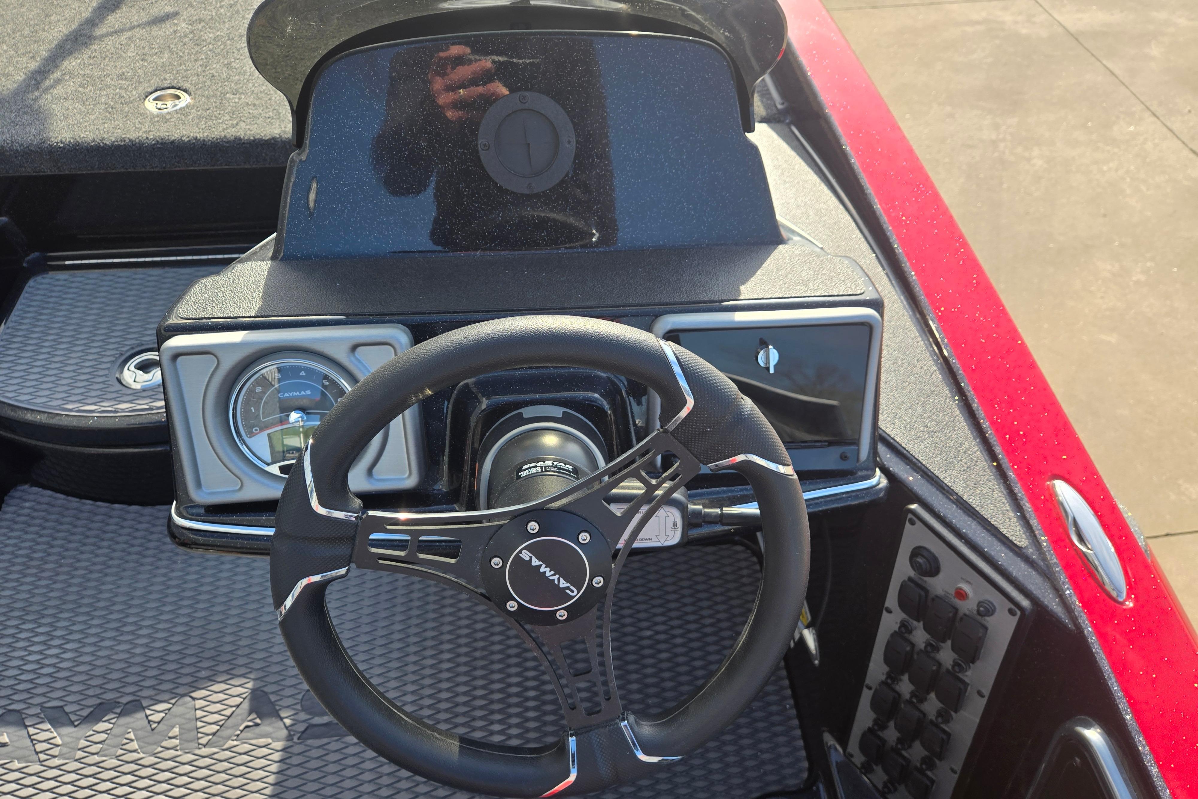 Steering wheel and dashboard of a 2027 Caymas 201 Pro boat.