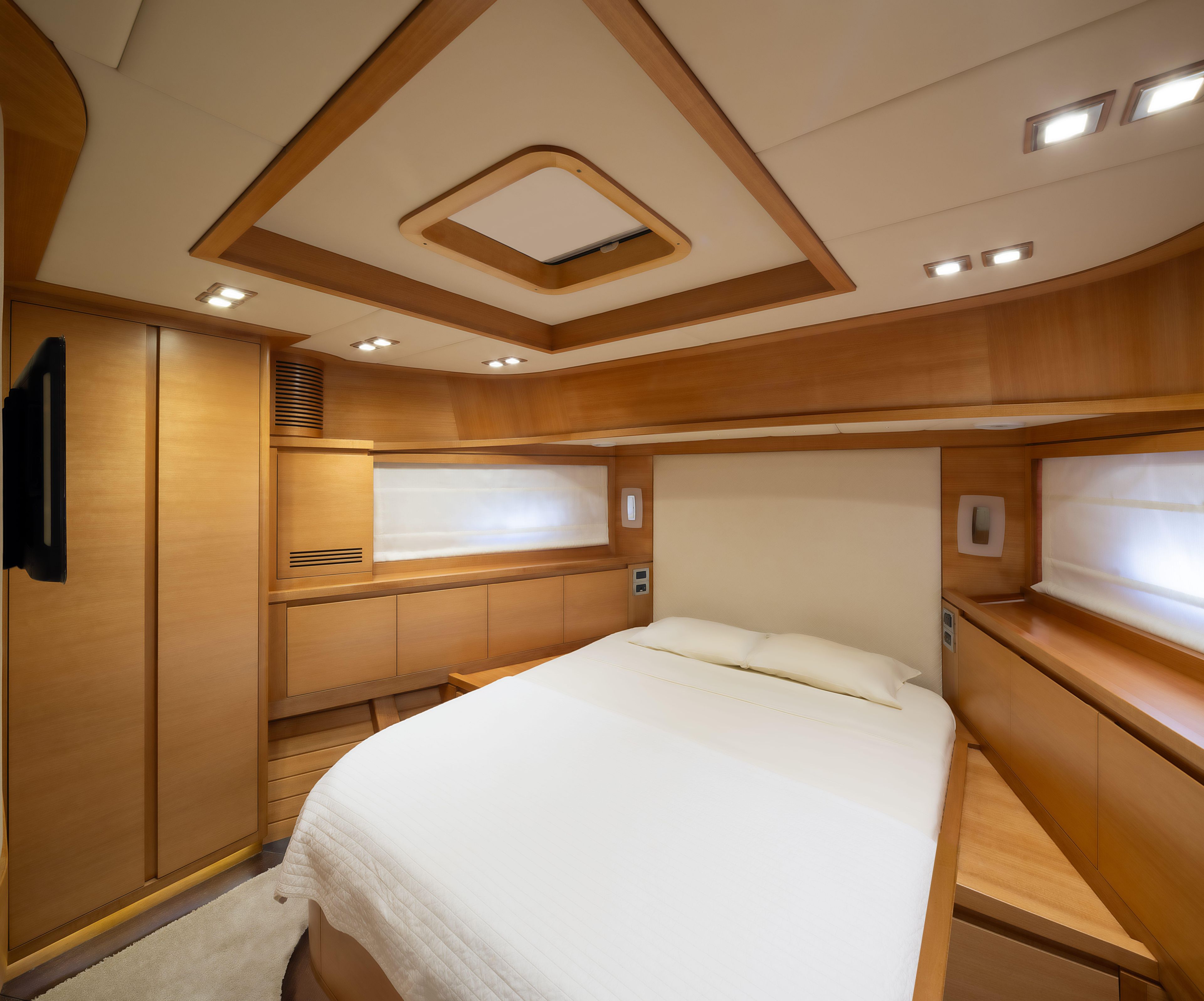 Luxurious bedroom interior of 2011 Vicem Cruiser 78 yacht with modern wood finish.